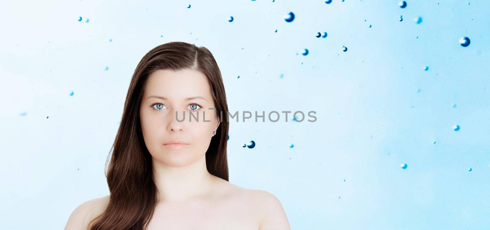 Rejuvenation skincare and beauty ad, beauty face portrait of young woman with healthy clean skin, blue cosmetic liquid drops on background.