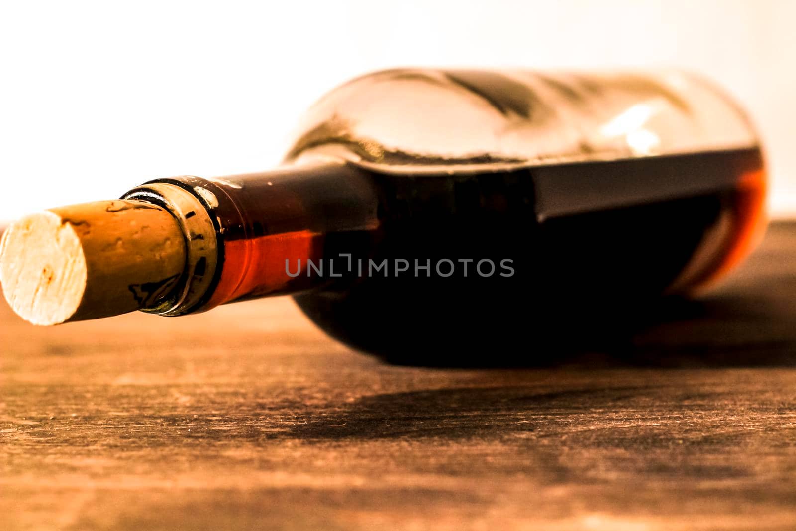 Bottle of red wine on wooden table. White background