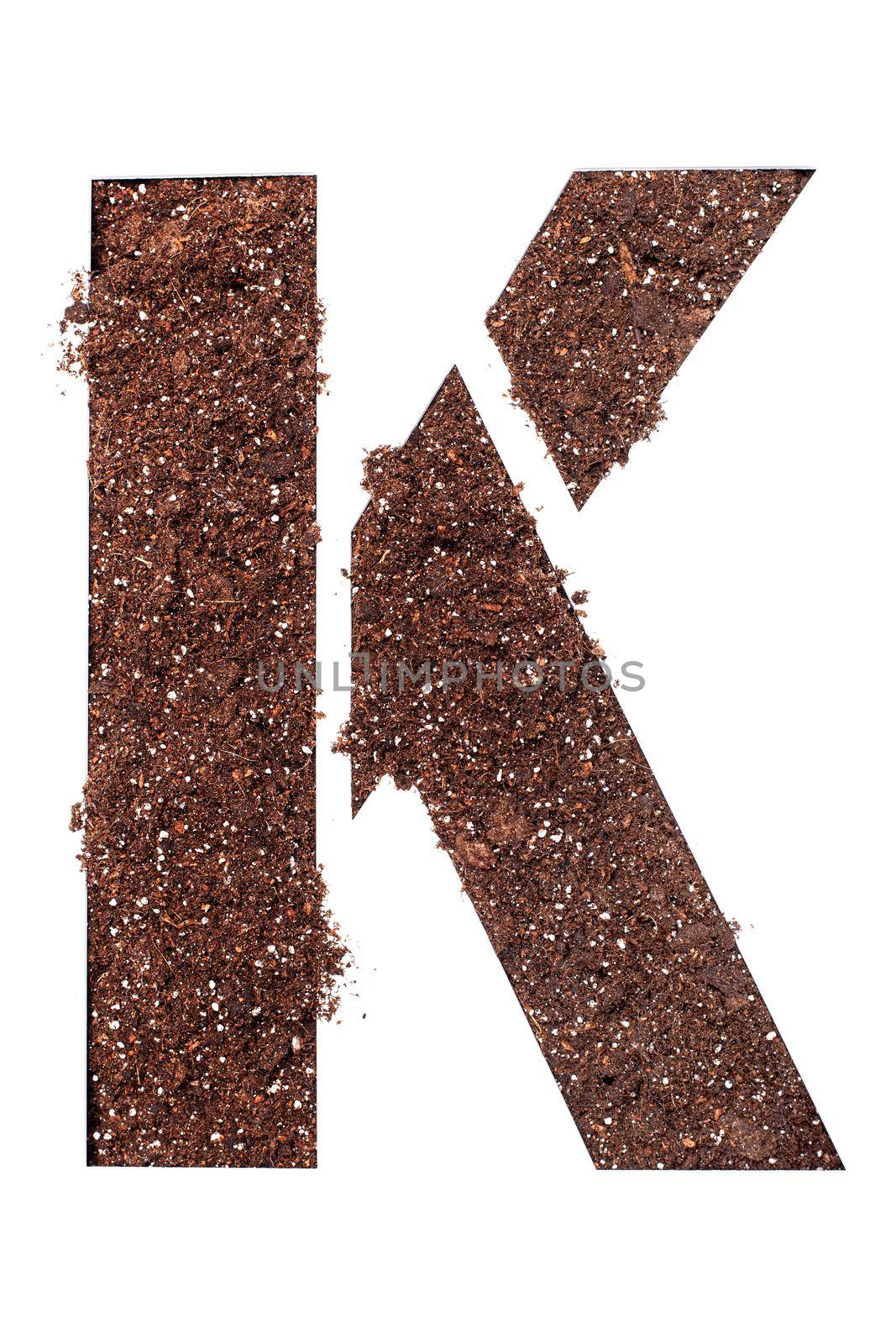 stencil letter K made above dirt on white surface by kokimk