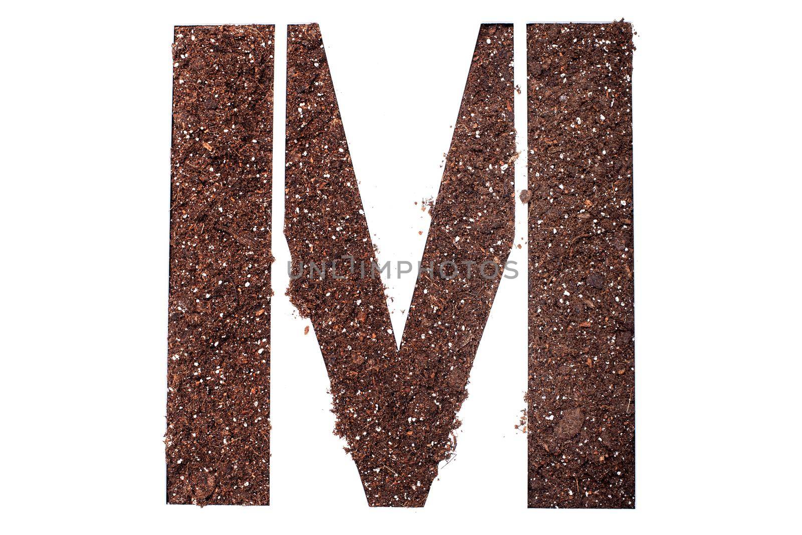 stencil letter M made above dirt on white surface by kokimk