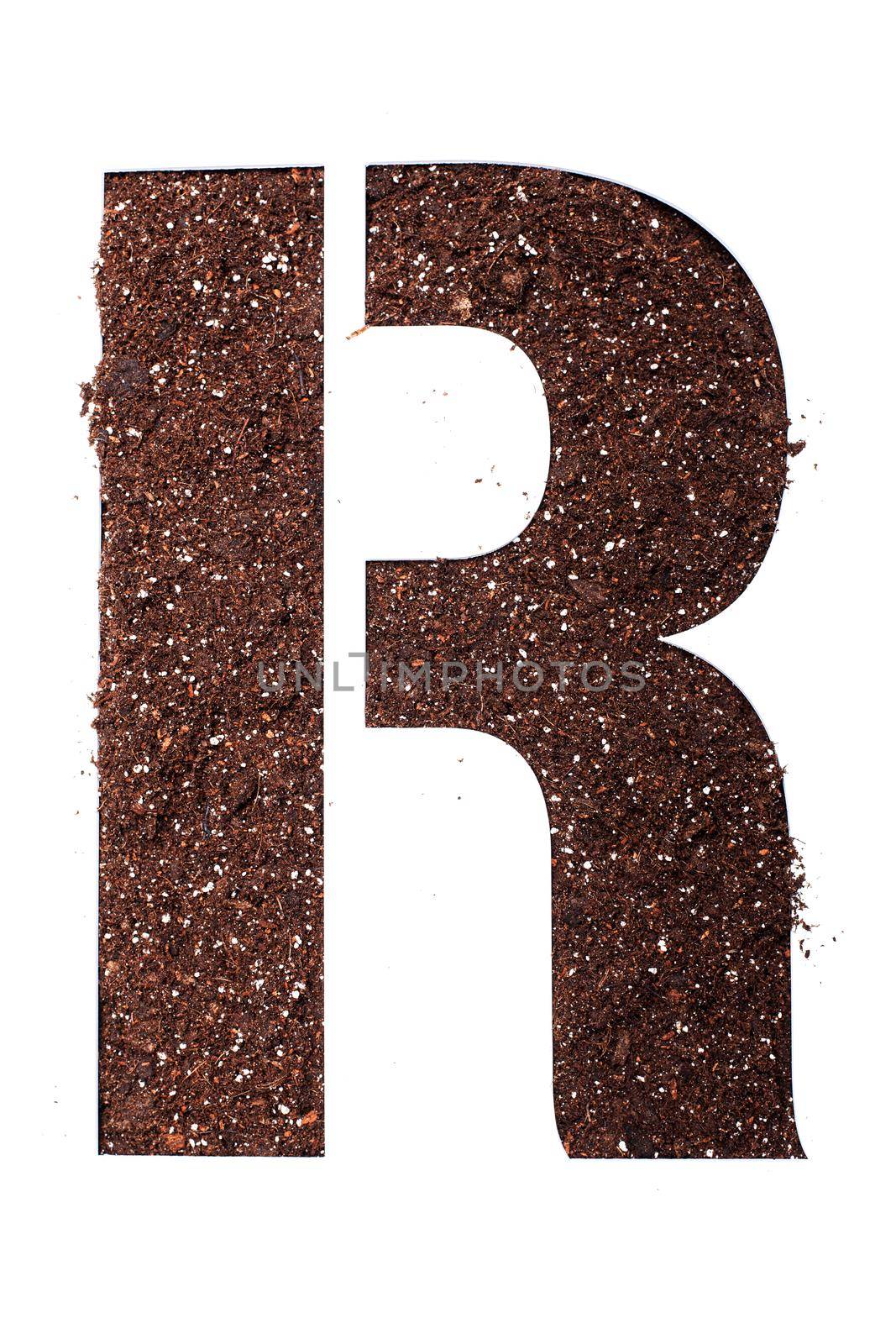 stencil letter R made above dirt on white surface by kokimk