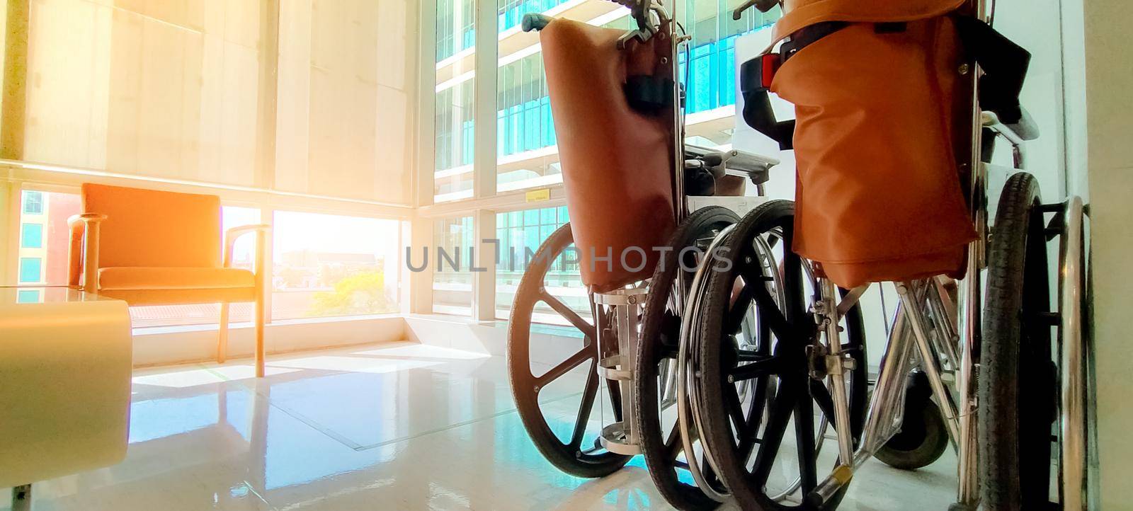 Empty wheelchair in private hospital for service patient and disabled people. Medical equipment in hospital for assistance handicapped old people. Chair with wheels for patient care in nursing home. by Fahroni