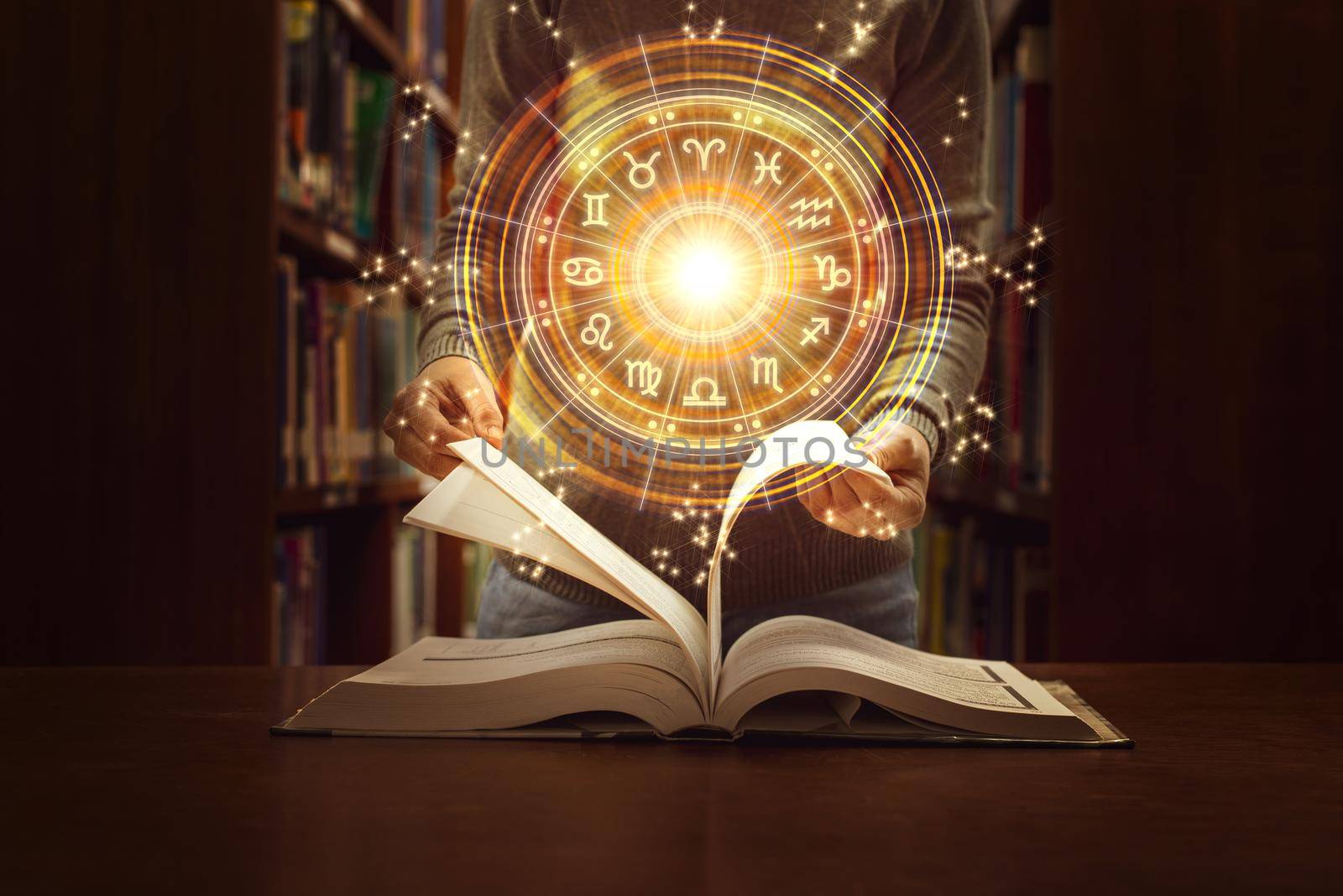 Woman reading a astrology book. Astrological wheel projection, choose a zodiac sign. Trust horoscope future predictions, consulting stars. Power of universe, astrology esoteric concept. by thanumporn