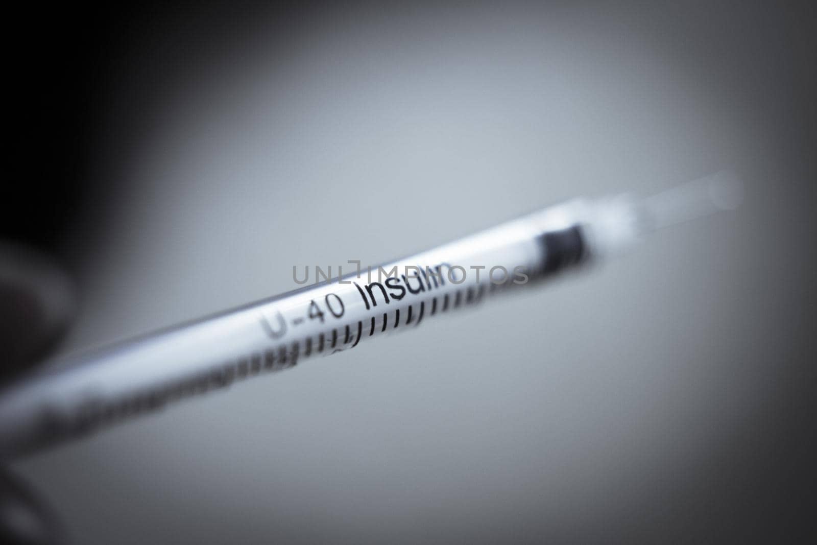 Insulin injecting syringe held by nurses hand. Copy space
