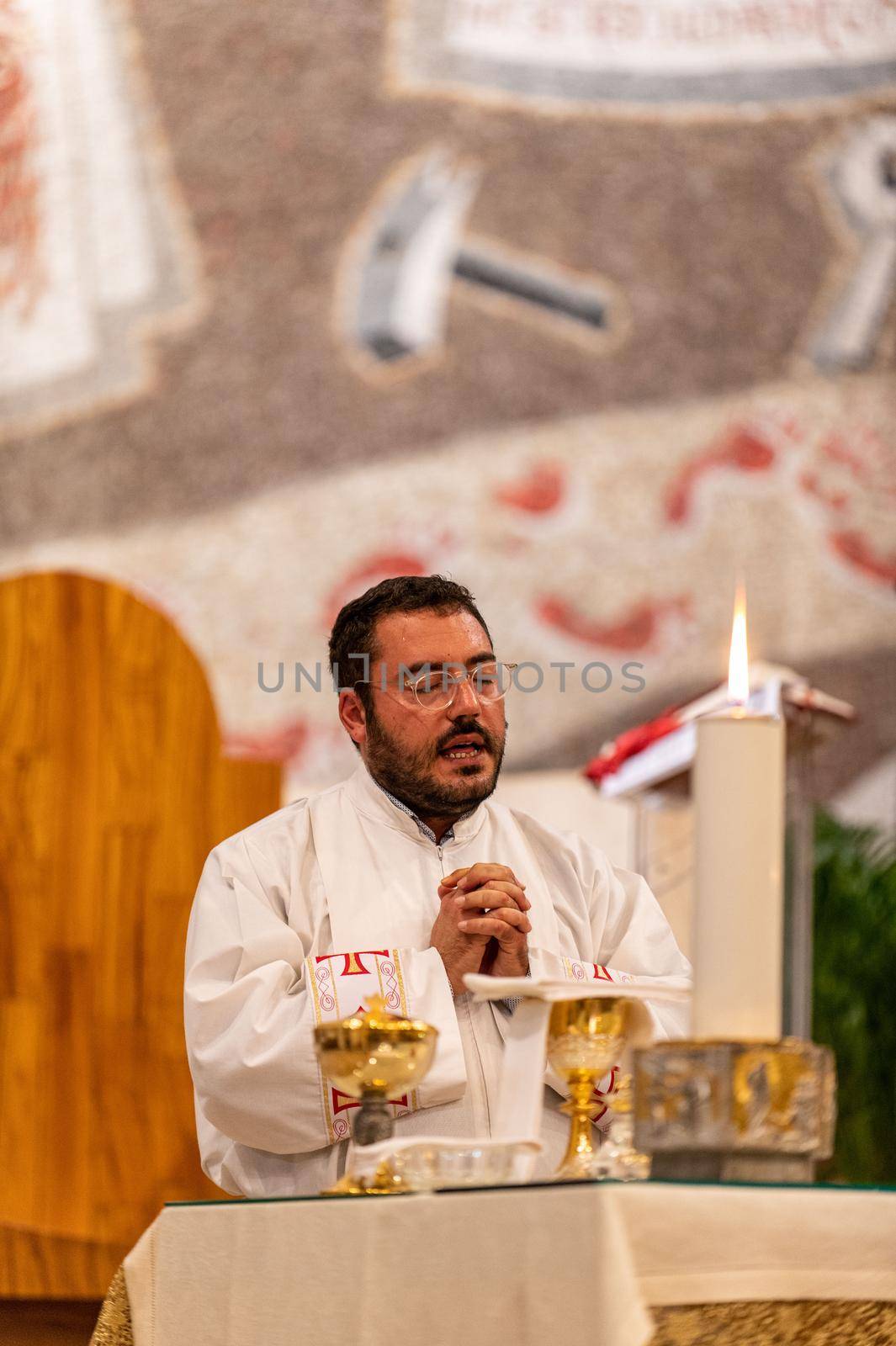 terni,italy may 21 2021:priests during the holy mass in the church of sacro cuore terni