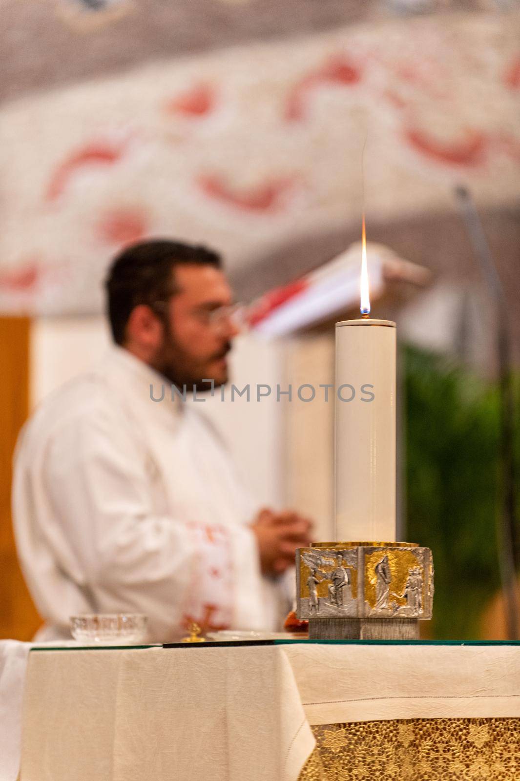 terni,italy may 21 2021:priests during the holy mass in the church of sacro cuore terni