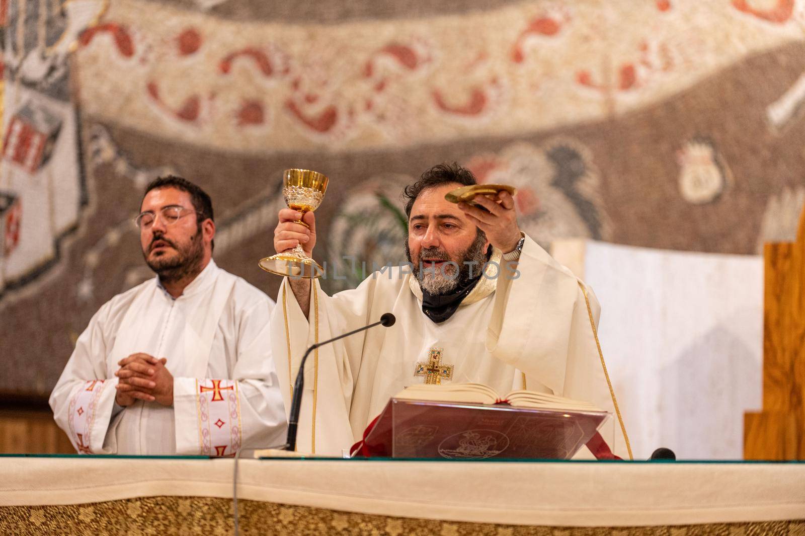 terni,italy may 21 2021:priests during the holy mass in the church of sacro cuore terni