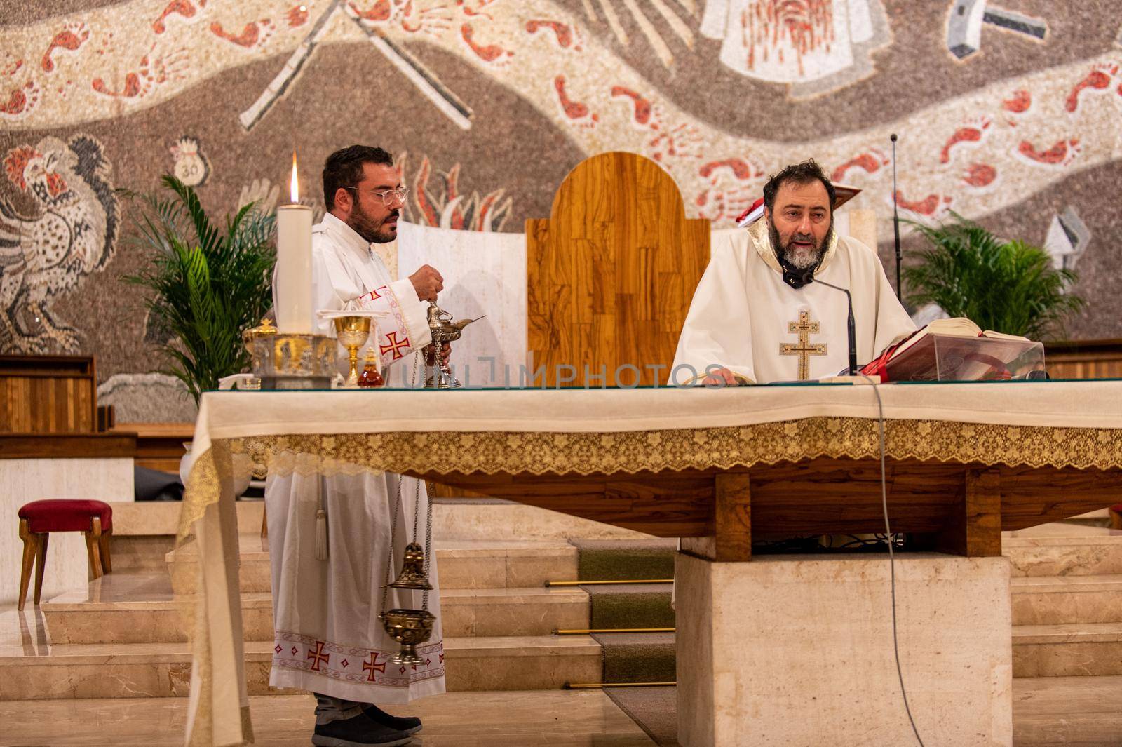 terni,italy may 21 2021:priests during the holy mass in the church of sacro cuore terni