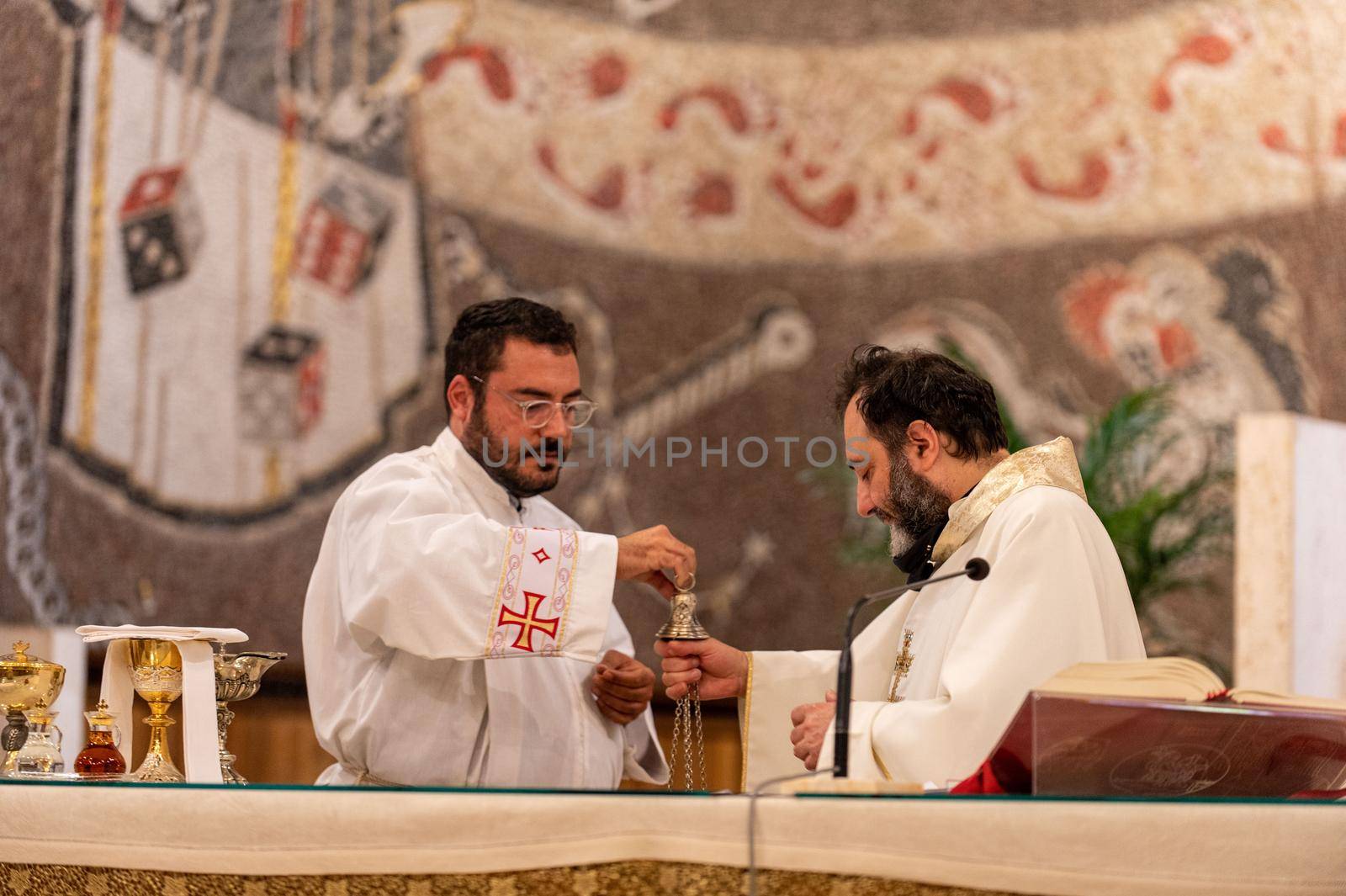 terni,italy may 21 2021:priests during the holy mass in the church of sacro cuore terni