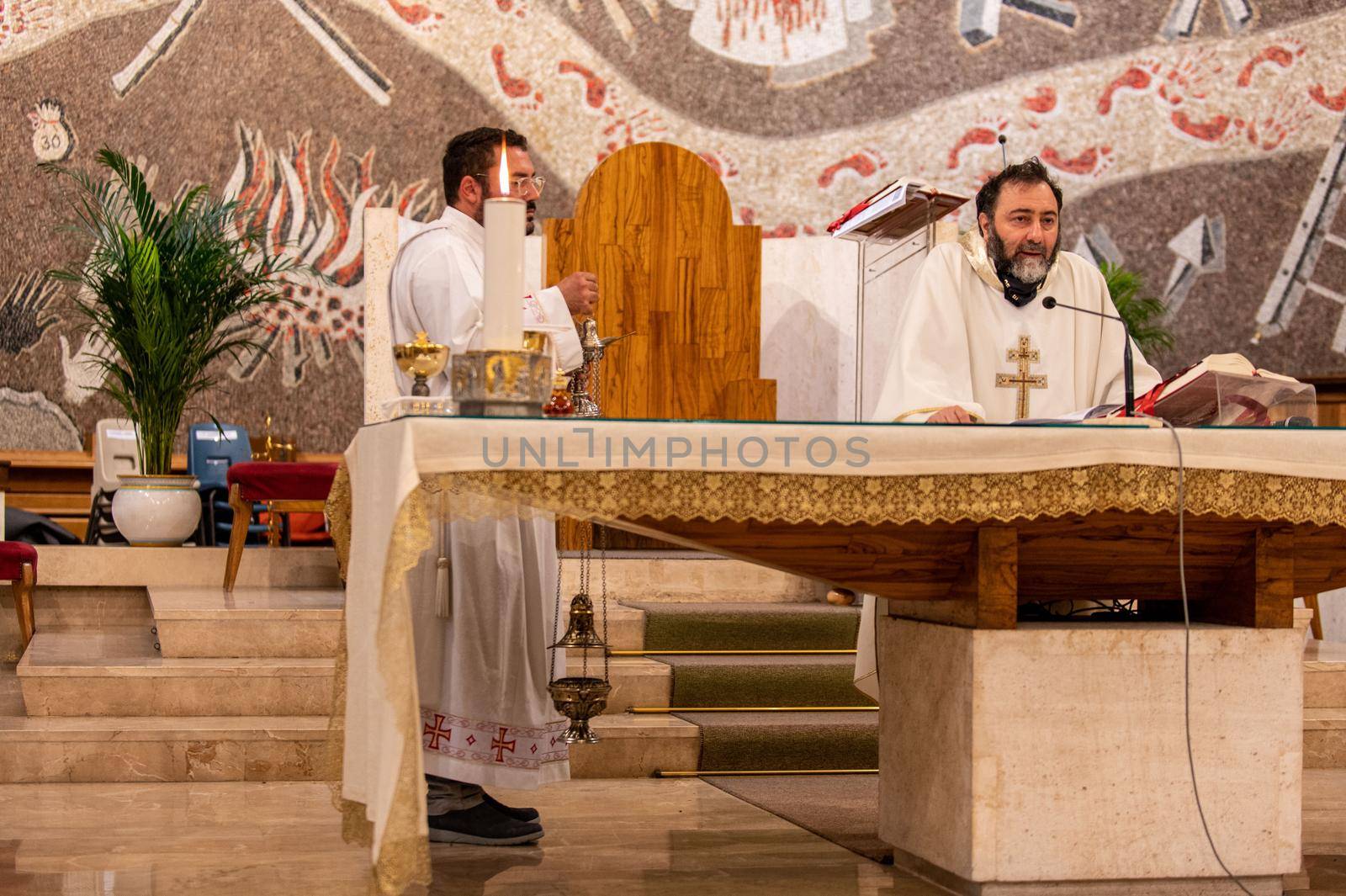 terni,italy may 21 2021:priests during the holy mass in the church of sacro cuore terni