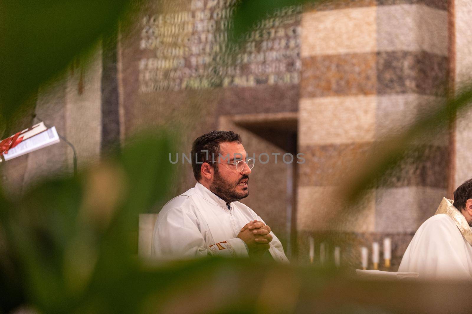 terni,italy may 21 2021:priests during the holy mass in the church of sacro cuore terni