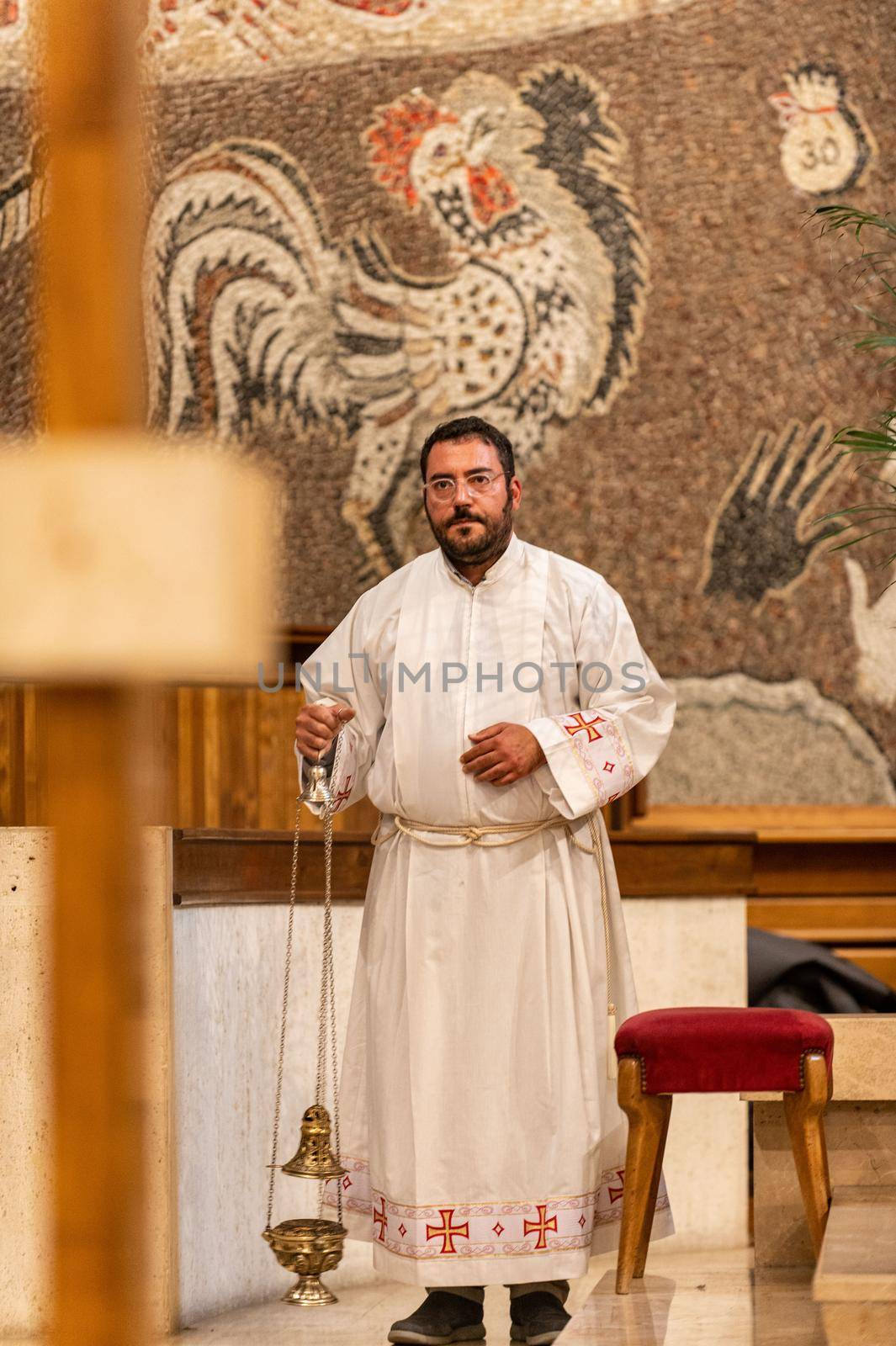 terni,italy may 21 2021:priests during the holy mass in the church of sacro cuore terni