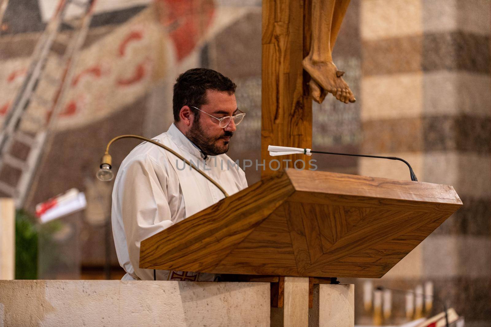 terni,italy may 21 2021:priests during the holy mass in the church of sacro cuore terni