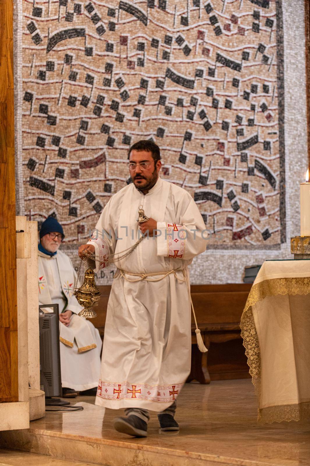 priests during the holy mass in the church of sacro cuore terni by carfedeph