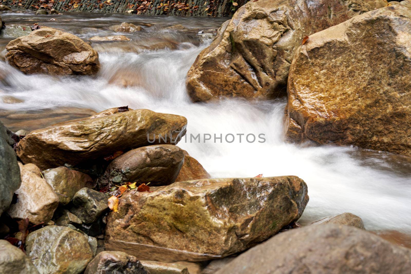 Mountain river with blured water close up by andreonegin