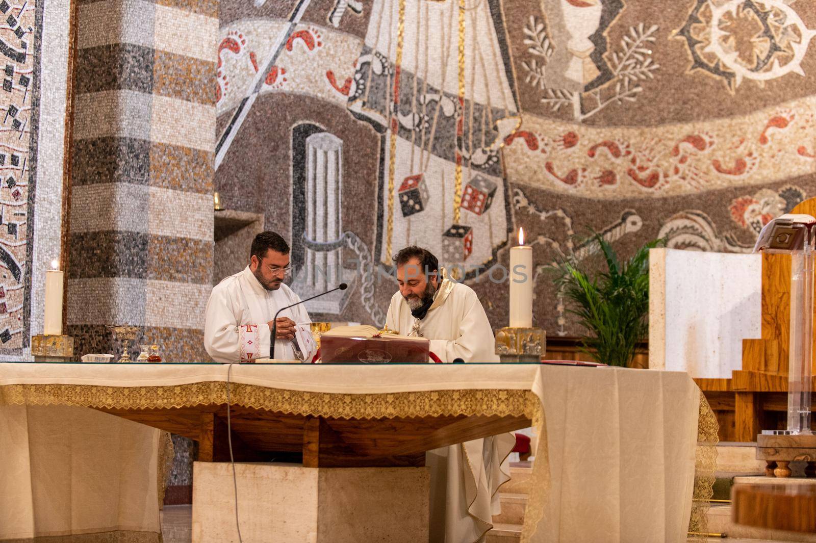 terni,italy may 21 2021:priests during the holy mass in the church of sacro cuore terni