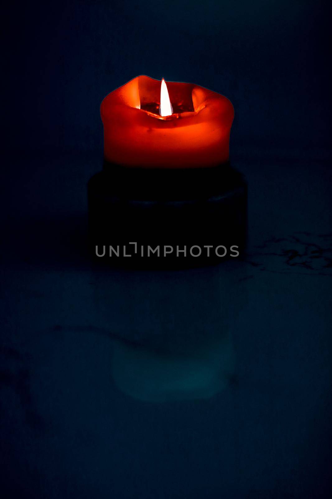 Happy holidays, greeting card backdrop and winter season concept - Red holiday candle on dark background, luxury branding design and decoration for Christmas, New Years Eve and Valentines Day