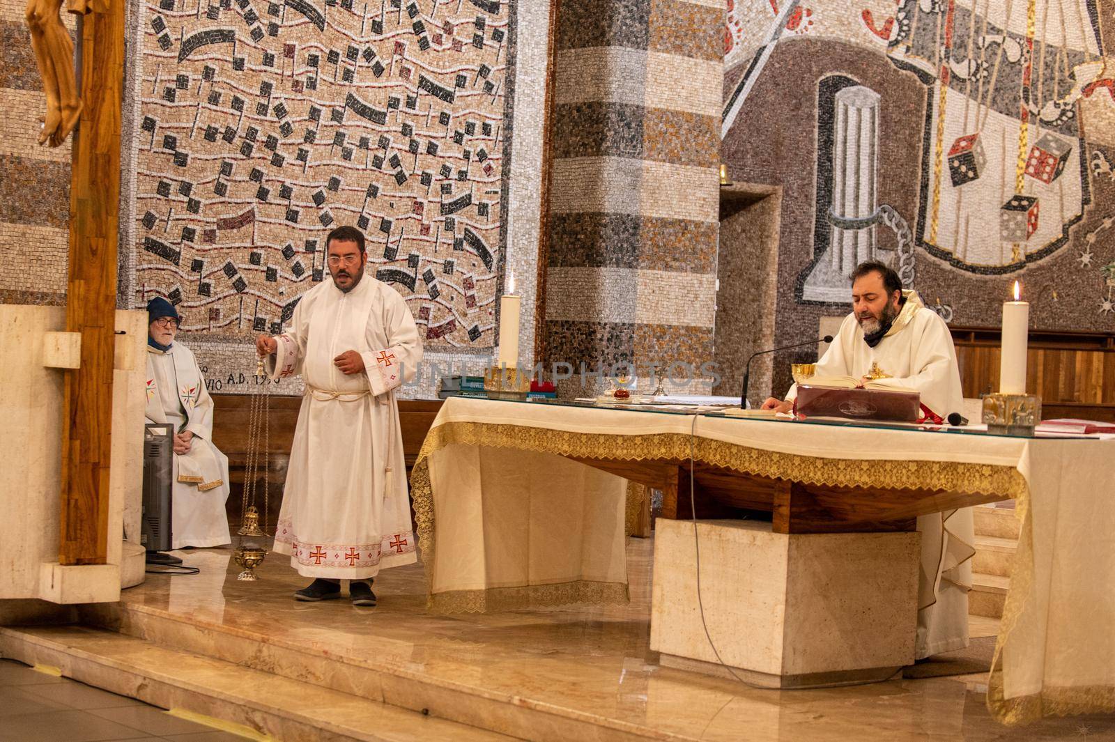 terni,italy may 21 2021:priests during the holy mass in the church of sacro cuore terni