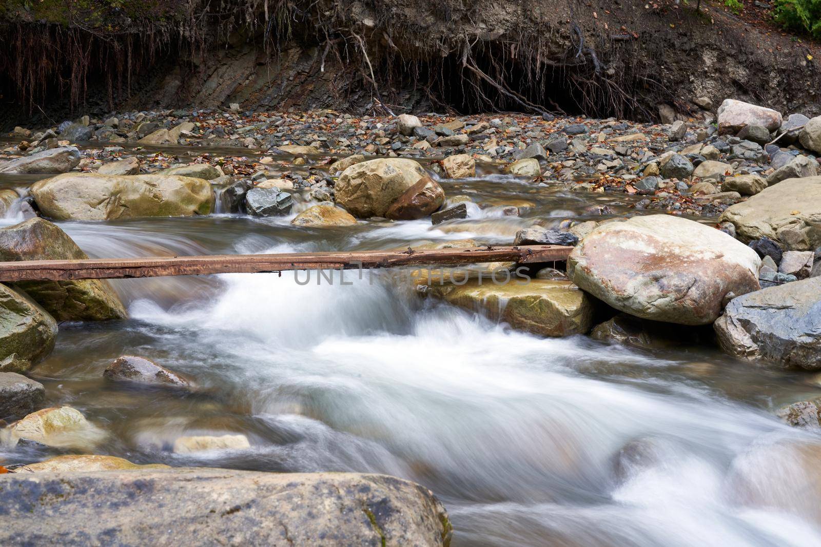 Mountain river with blured water close up by andreonegin