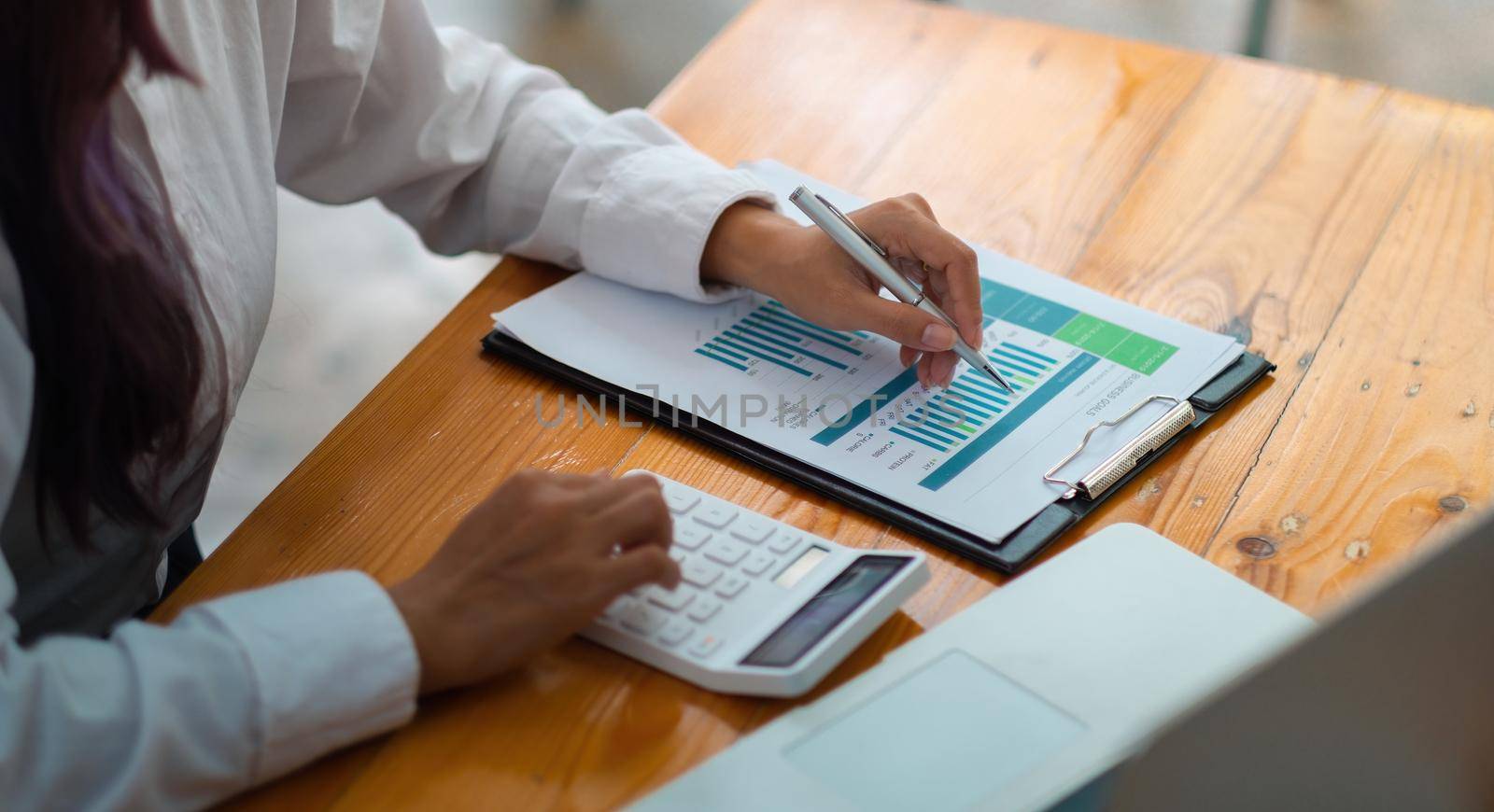 Financial Business woman analyze the graph of the company's performance to create profits and growth, Market research reports and income statistics, Financial and Accounting concept.