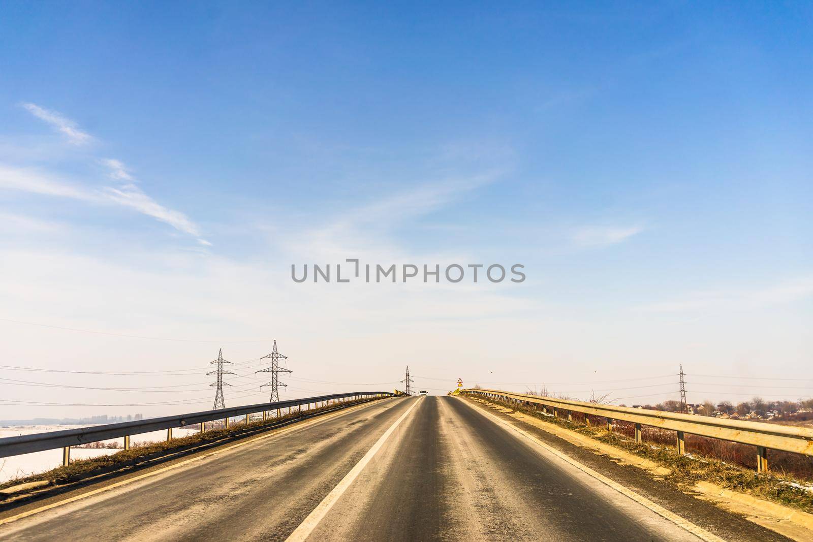 Winter season, view of cars and snowy street through windshield while driving in Bucharest, Romania, 2021.