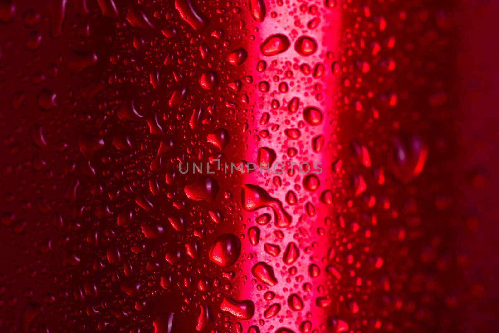 Water droplets on red metallic can