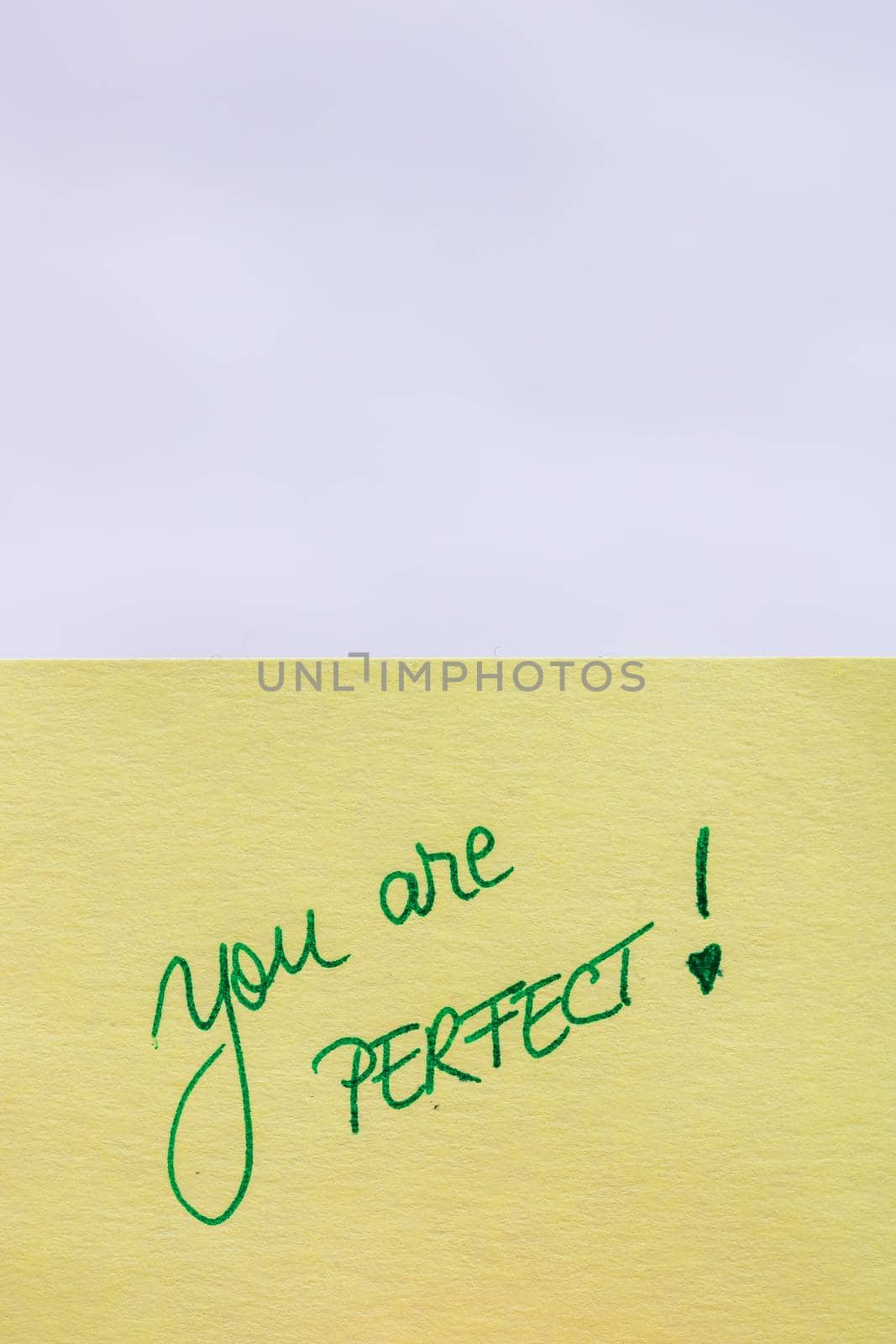 You are perfect handwriting text close up isolated on yellow paper with copy space. by vladispas