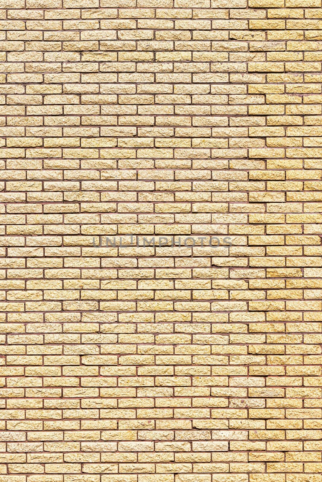 Yellow decorative brick wall texture. Abstract background for design.