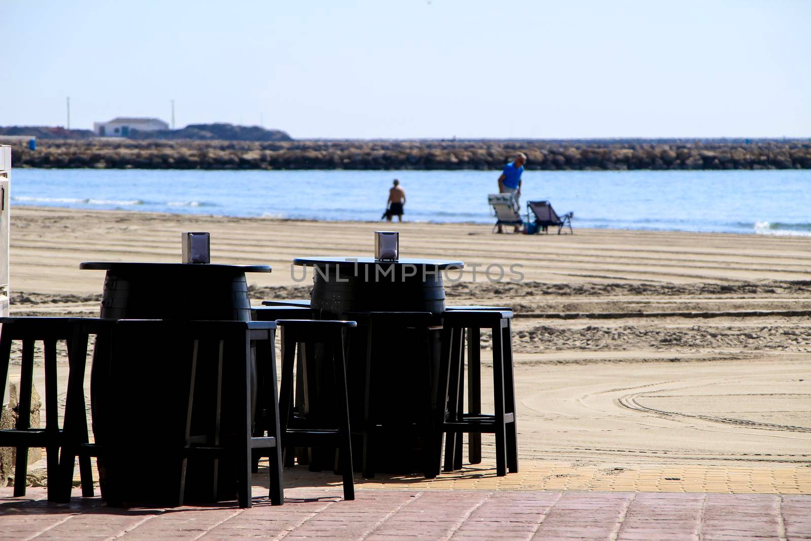 Bar with empty terrace on Santa Pola beach on a sunny day