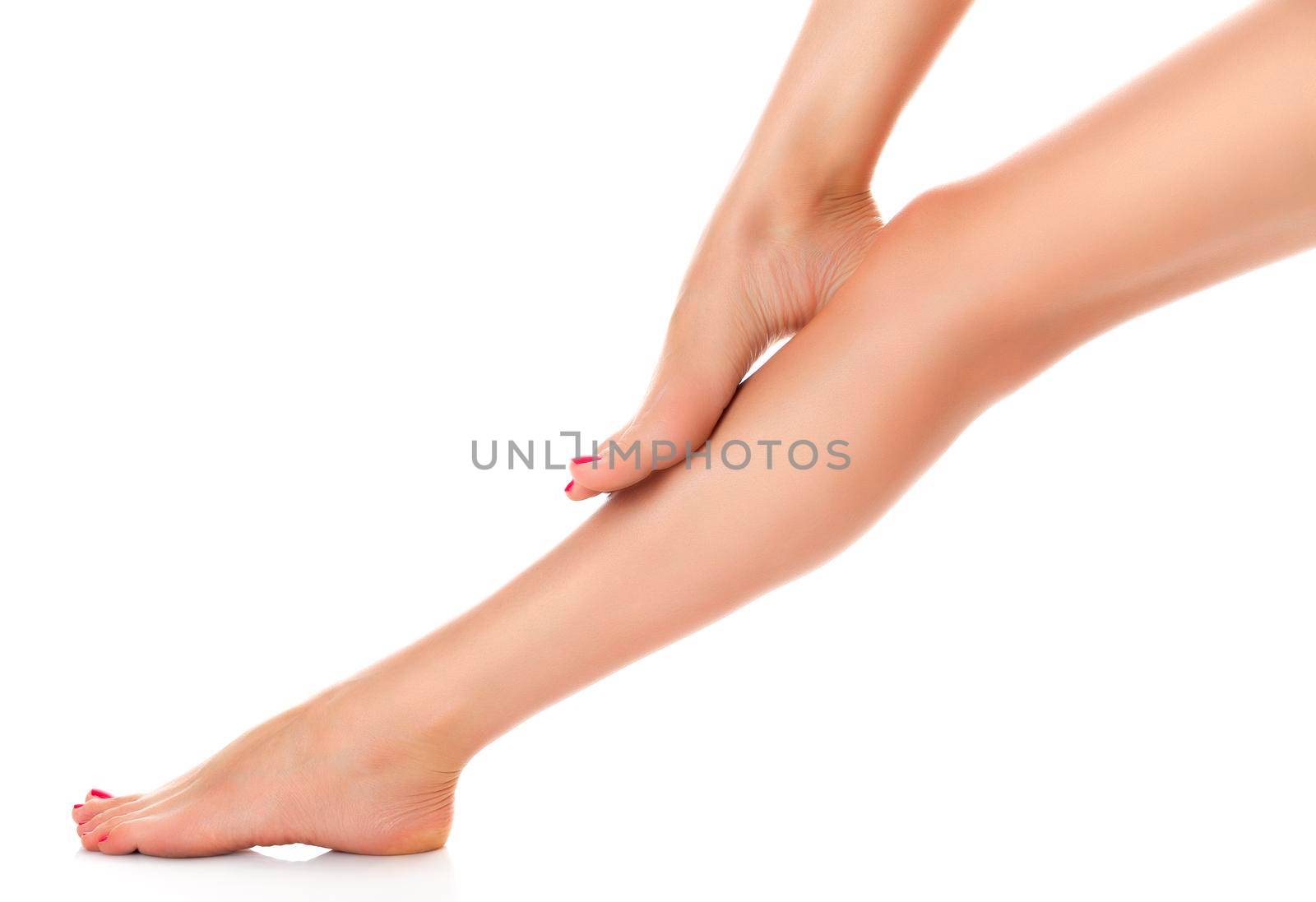 Beautiful female legs isolated on white background. Skin care concept