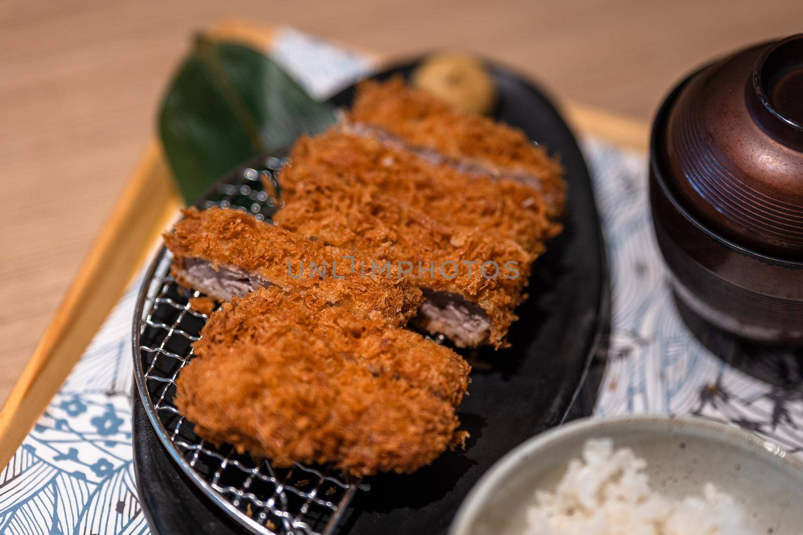Japanese pork cutlet on a table by uphotopia