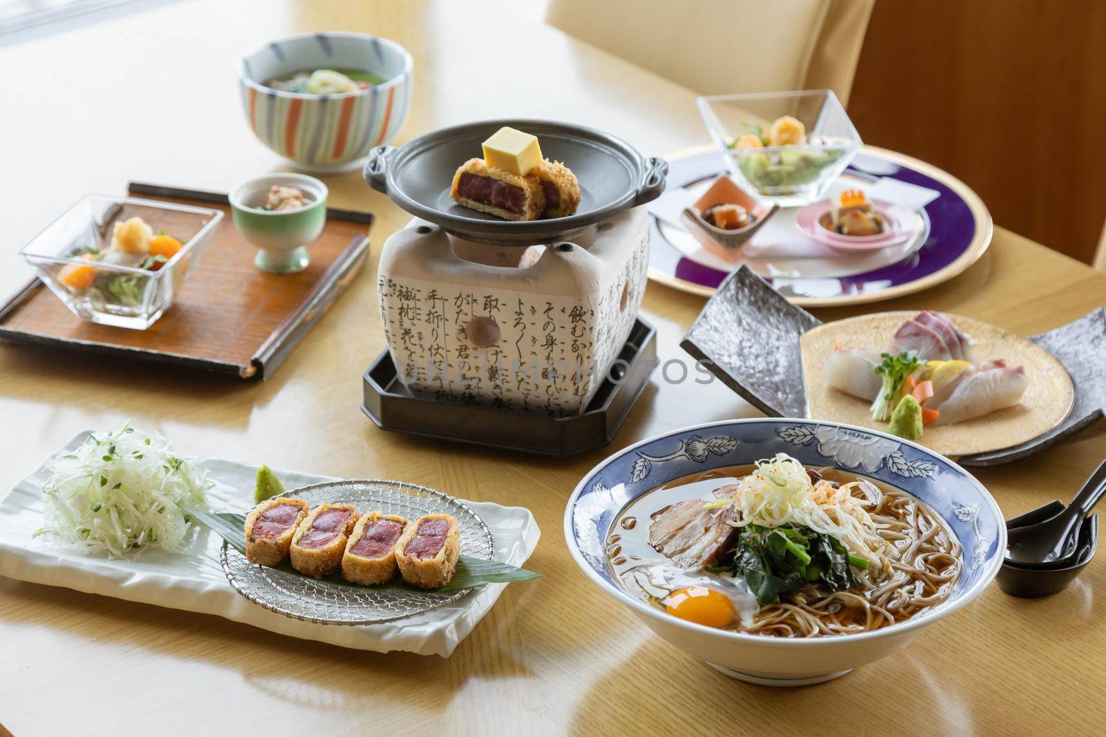 Mix of Japanese food on restaurant table by uphotopia