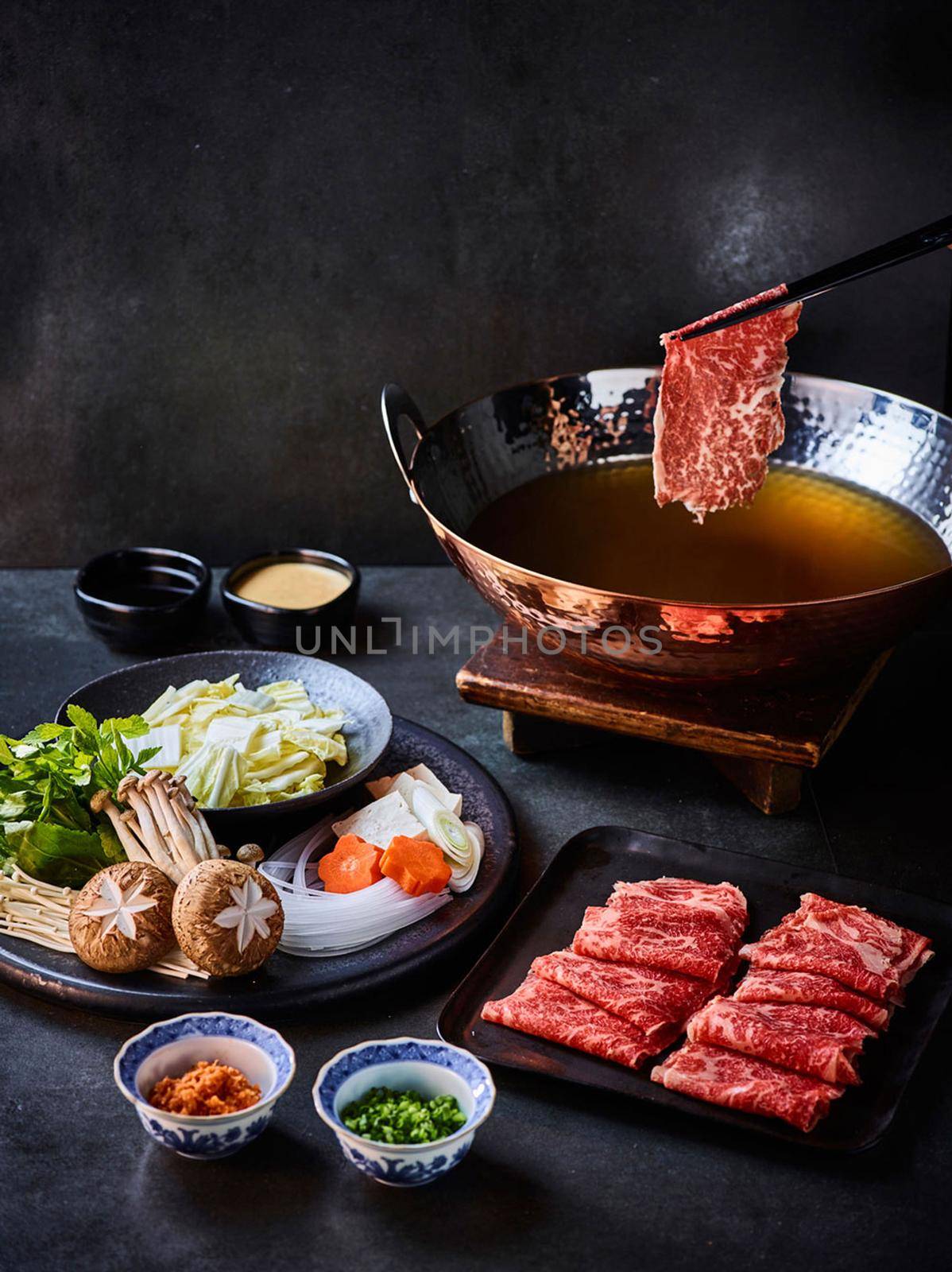 Shabu-shabu served on a table by uphotopia