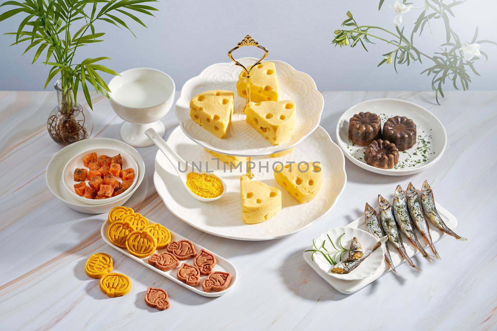 Yellow cheeses and cookies on a table by uphotopia