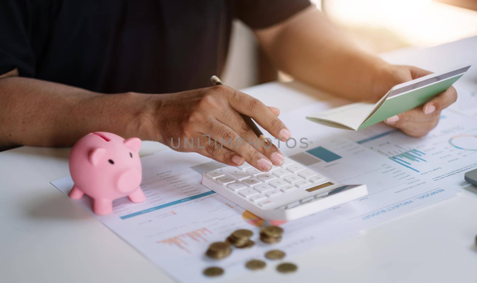 Business man hands holding saving account passbook with calculator, account and saving concept.