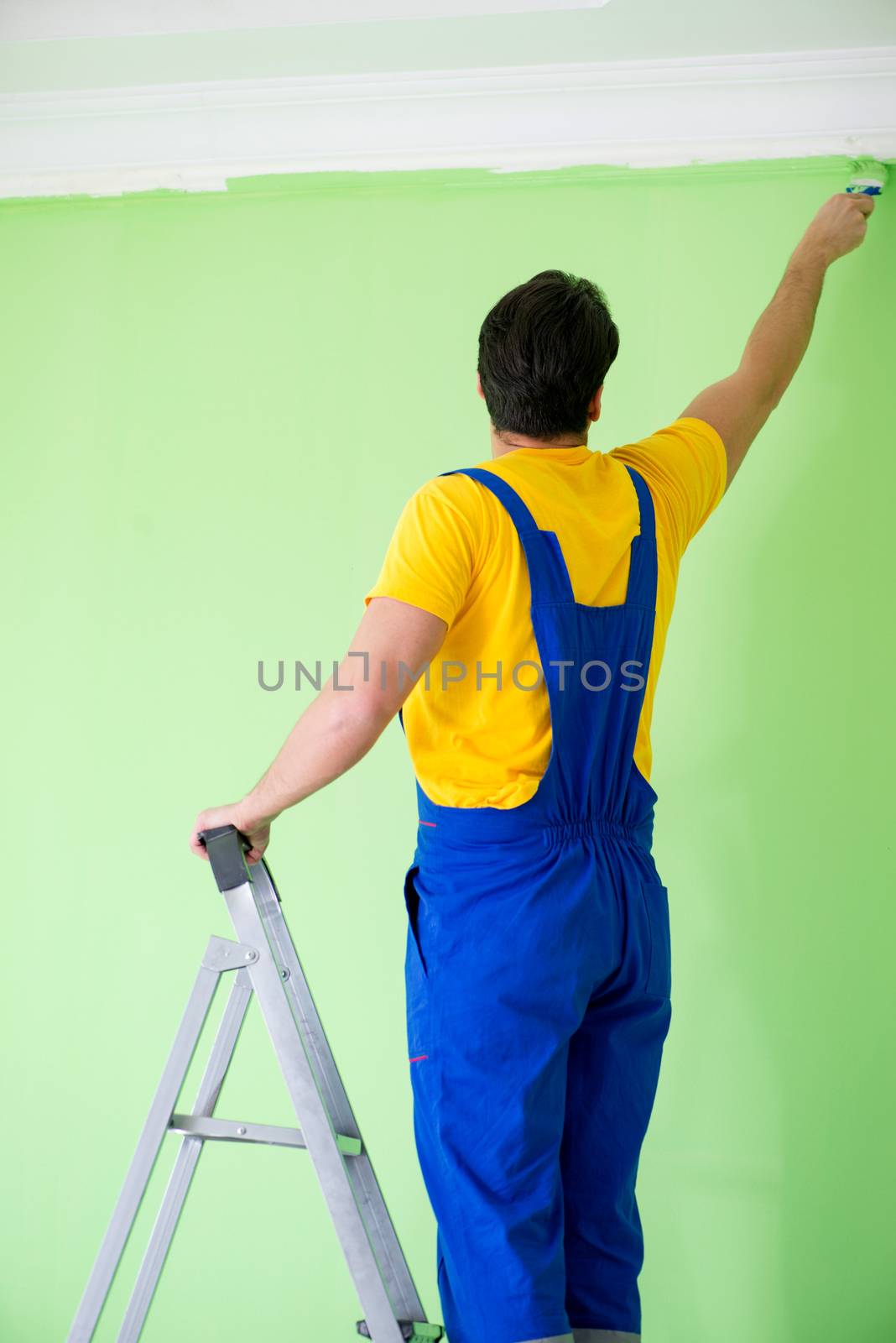 Young painter doing renovation at home 