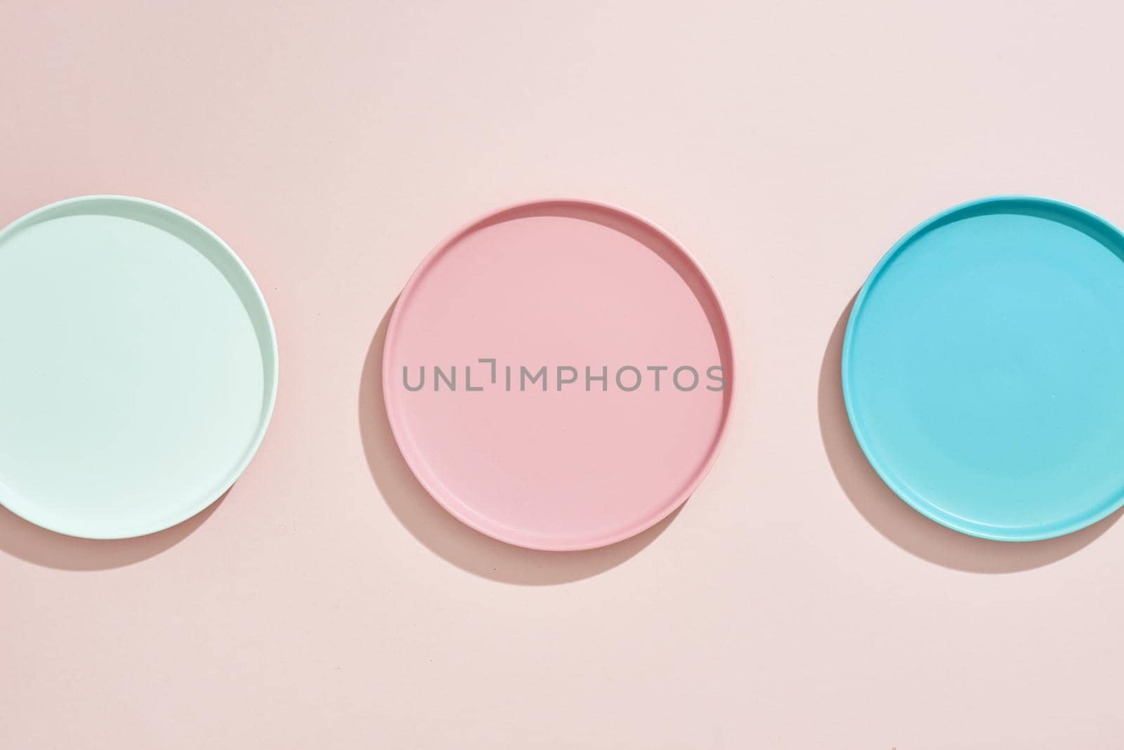 Pink, light blue, blue, pastel color plates set isolated on pink by makidotvn