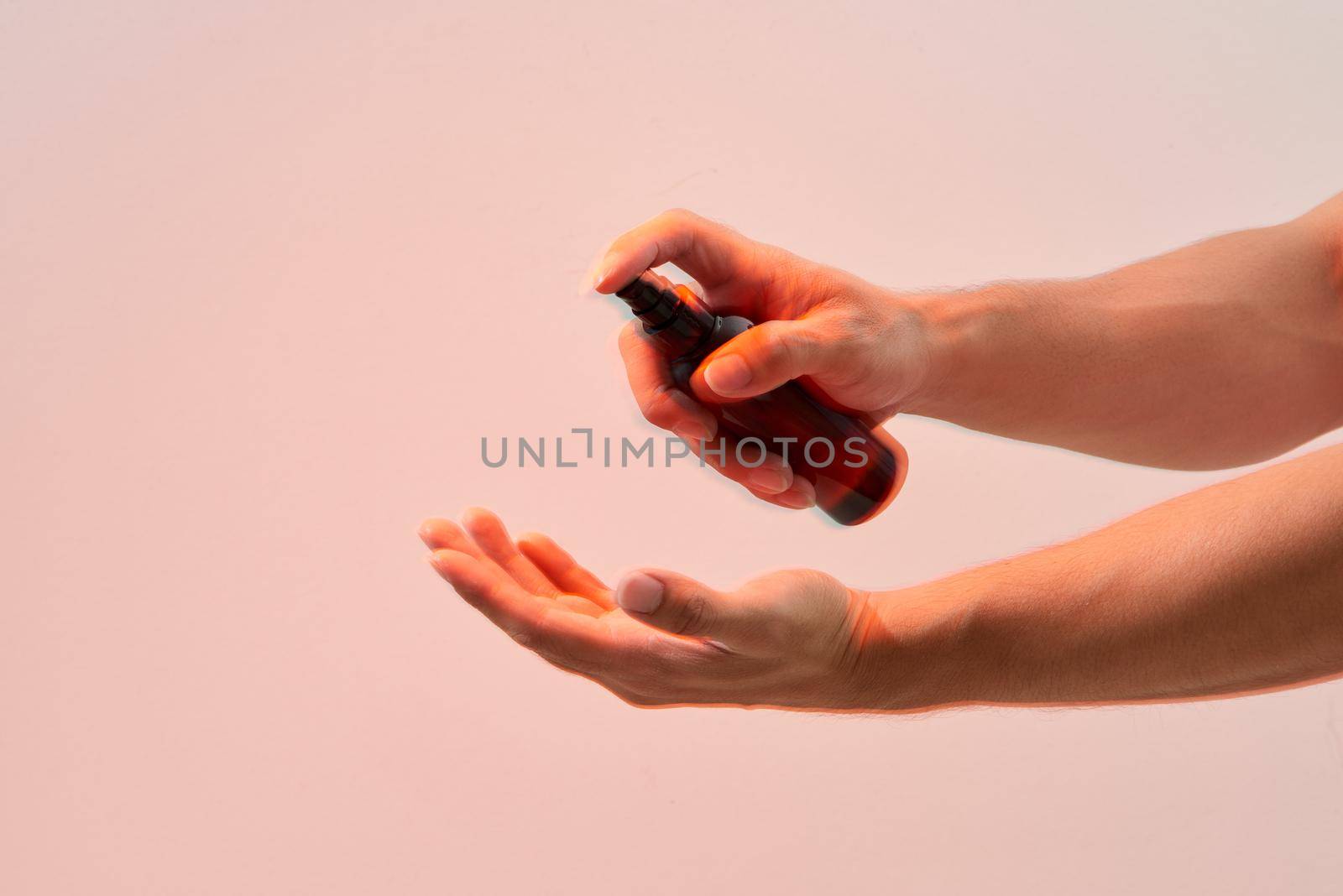 Hand of lady that applying alcohol spray or anti-bacteria spray to prevent the spread of germs, bacteria and virus. Personal hygiene concept. by makidotvn