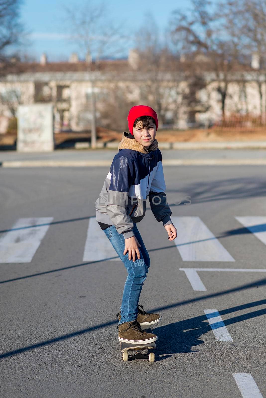 Teenager skateboarder boy with a skateboard on asphalt playground doing tricks. Youth generation Free time spending concept image.