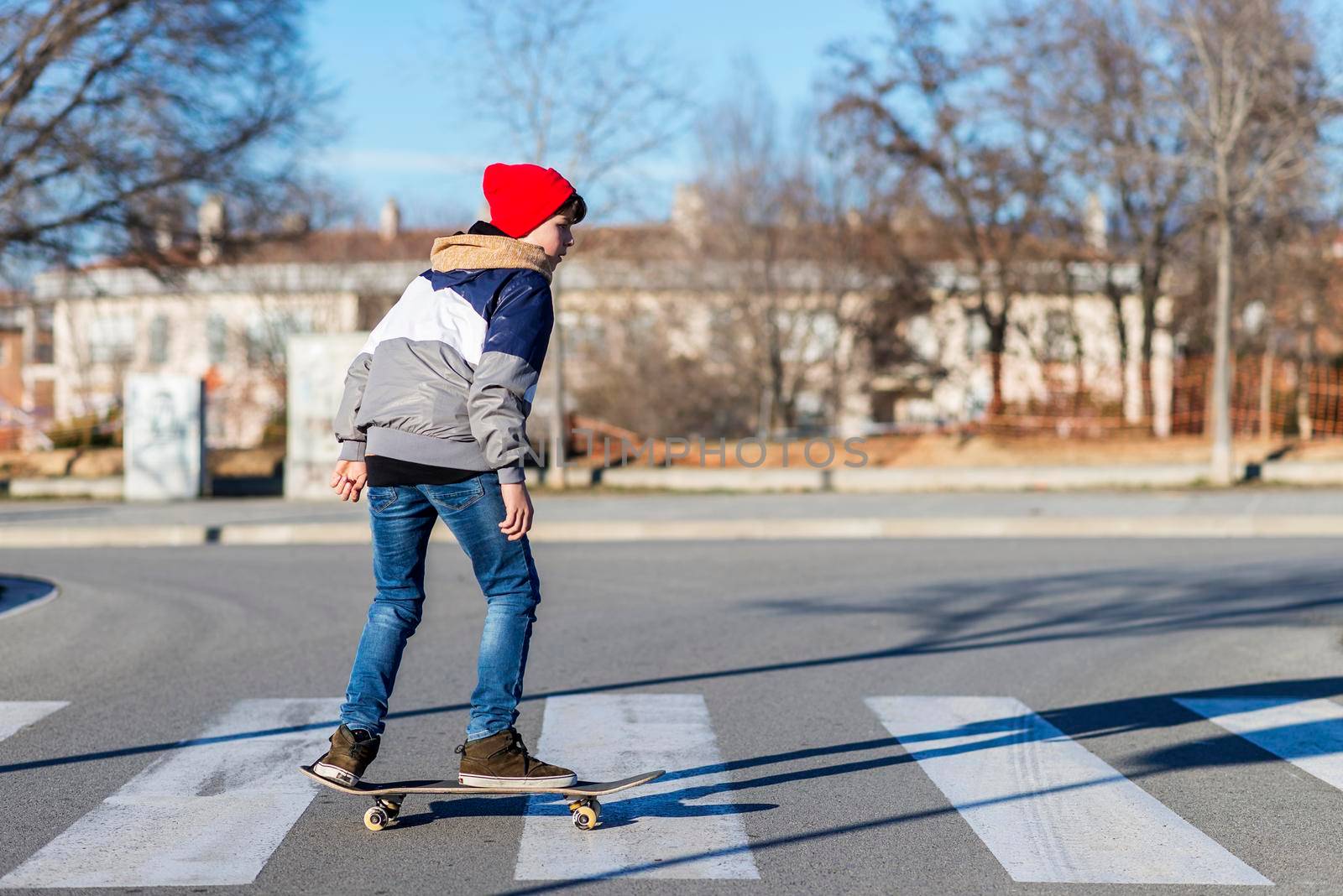 Teenager skateboarder boy with a skateboard on asphalt playground doing tricks. Youth generation Free time spending concept image.