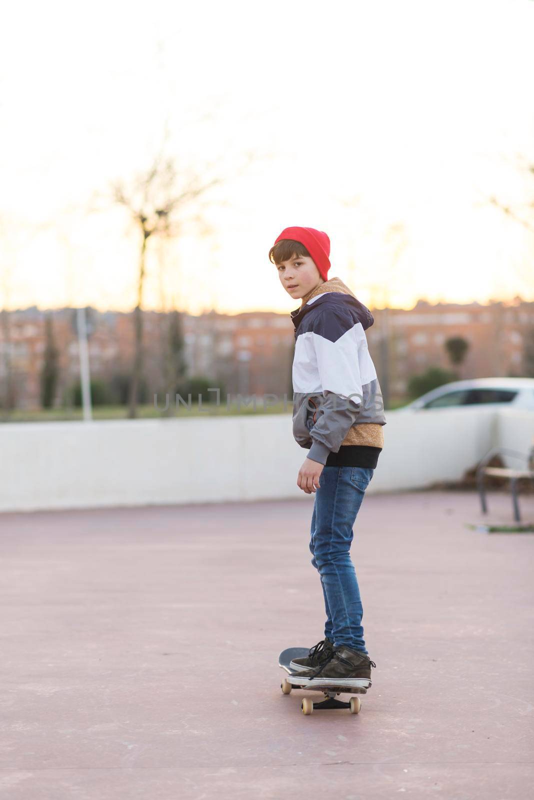 Teenager skateboarder boy with a skateboard on asphalt playground doing tricks. Youth generation Free time spending concept image.