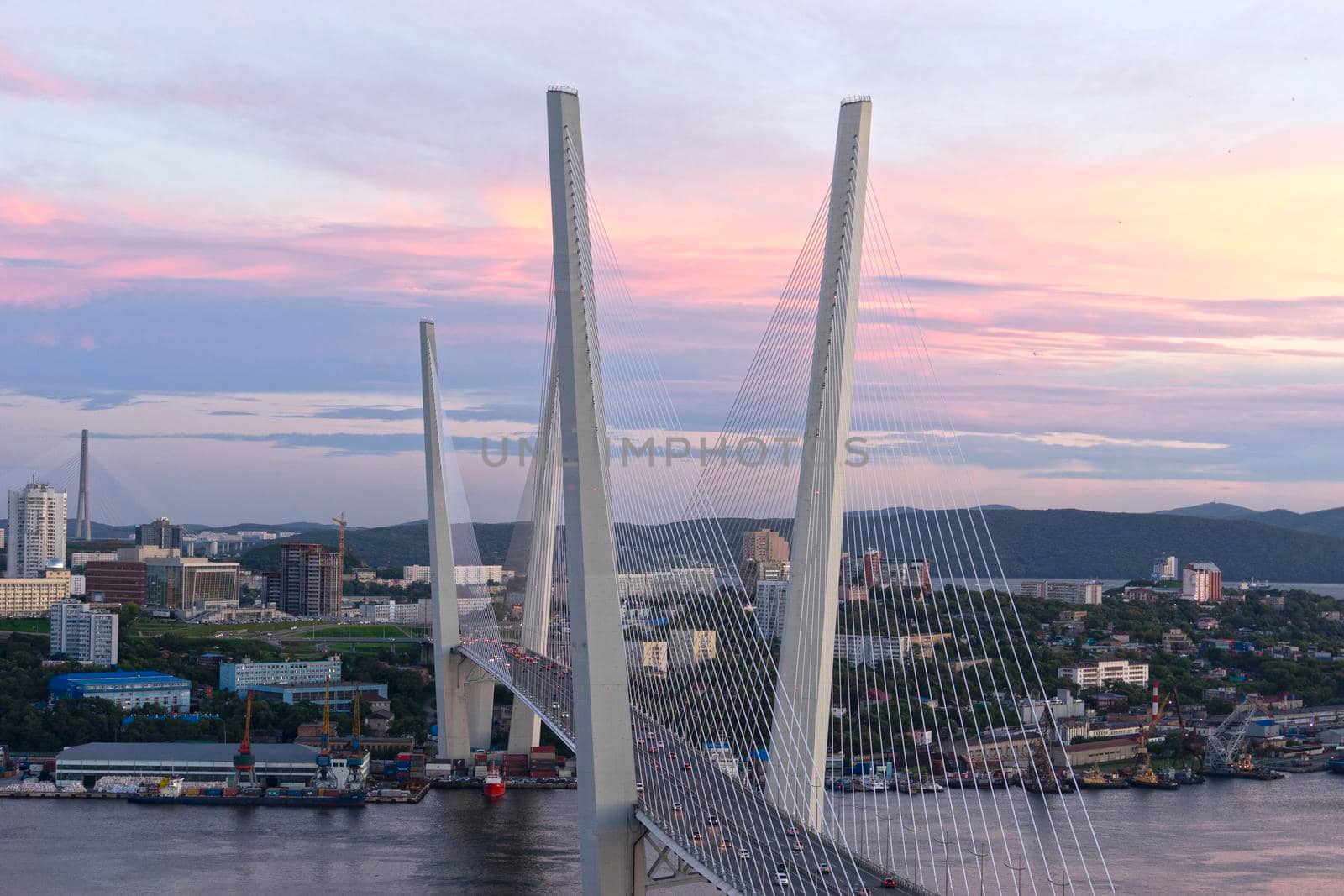 Urban landscape with a view of the Golden Bridge at sunset. Vladivostok, Russia.