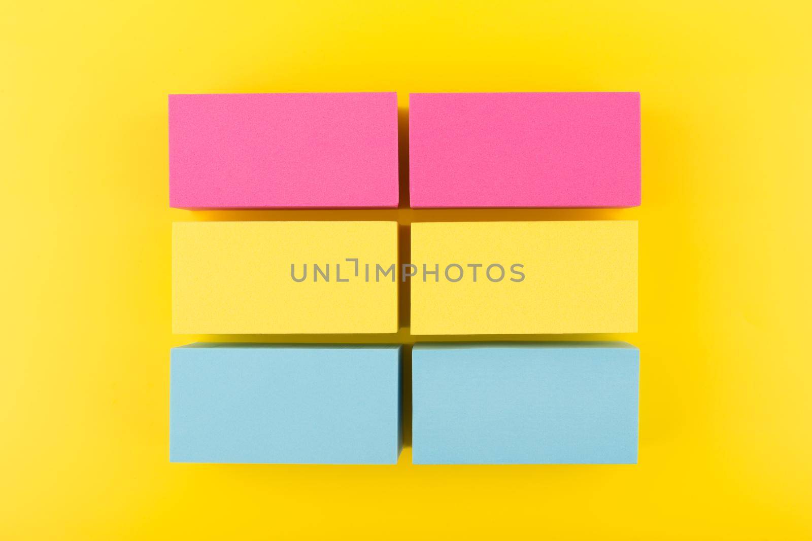 Pansexual flag made of pink, yellow and blue blocks on yellow background. Concept of pansexual community, sexual minorities and tolerance