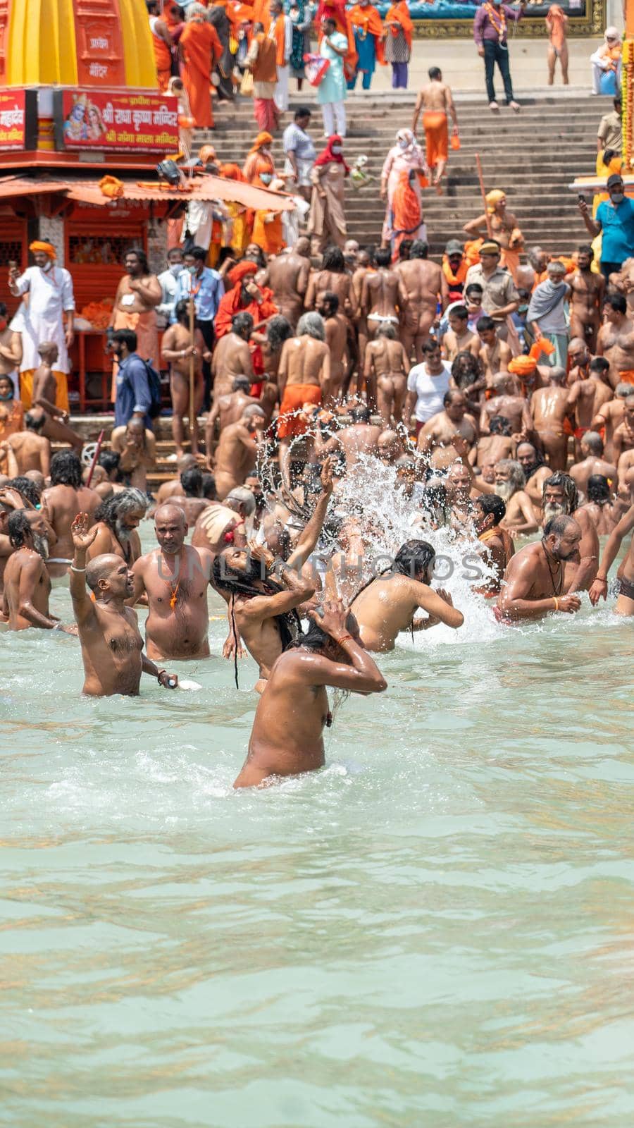 Haridwar, Uttarakhand India April 06, 2021. A Dip of Spirituality and faith, Maha Kumbh 2021. Morning Time dip, Indian saints batting in Ganges of Ganga River and Worshipping their God. High-quality