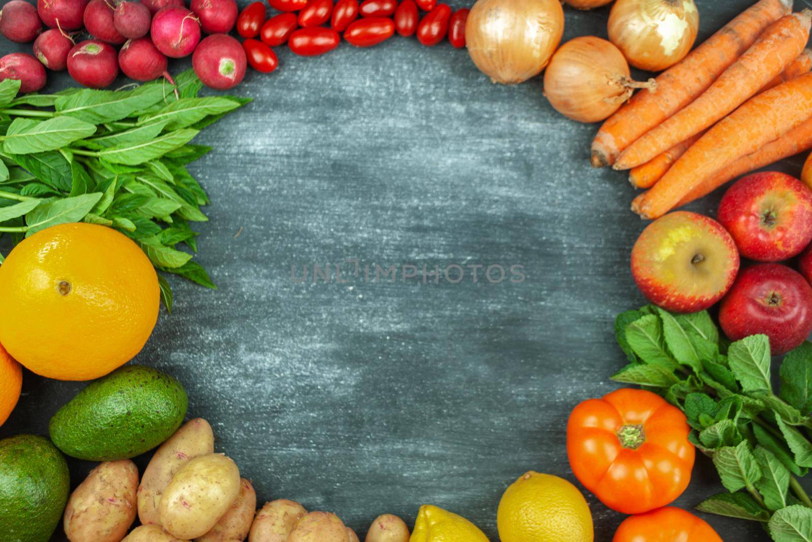 Flat lay of multicolored raw vegetables on a black background, round frame of food. Local products for healthy cooking. Organic fruits and vegetables for vegetation. Top view. Copy space.