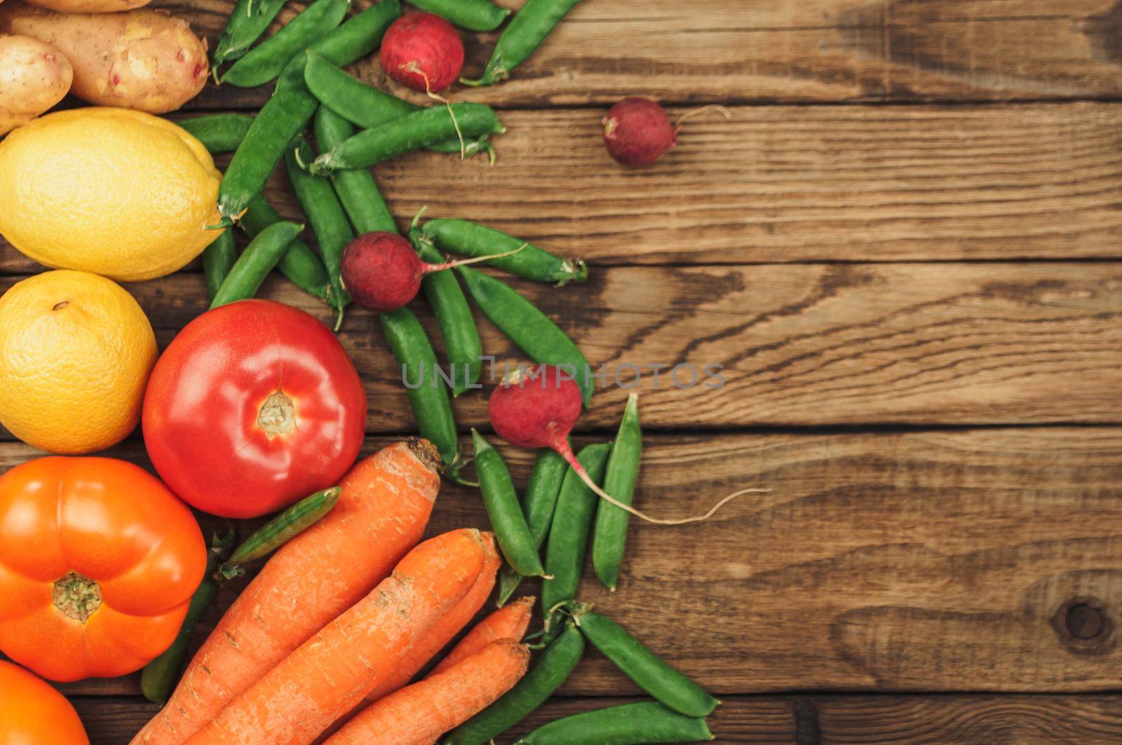 Flat lay of seasonal fruits, vegetables and herbs. Summer food concept. Healthy life and vegetarian, vegan, diet, clean food ingredients. Place for text. Food on a dark wooden background.