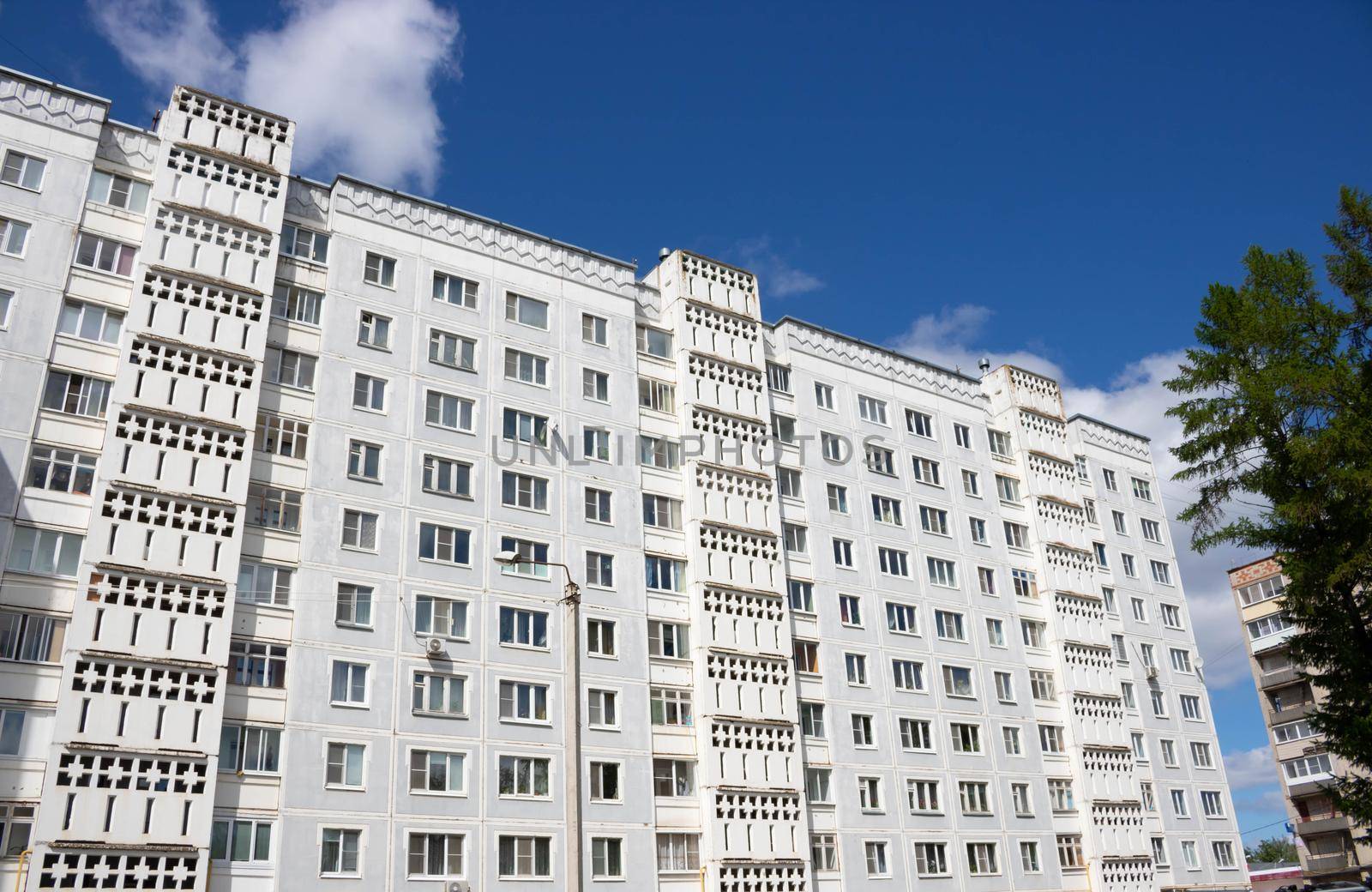 View from below on the facade of a modern multi-storey building with beautiful balconies.