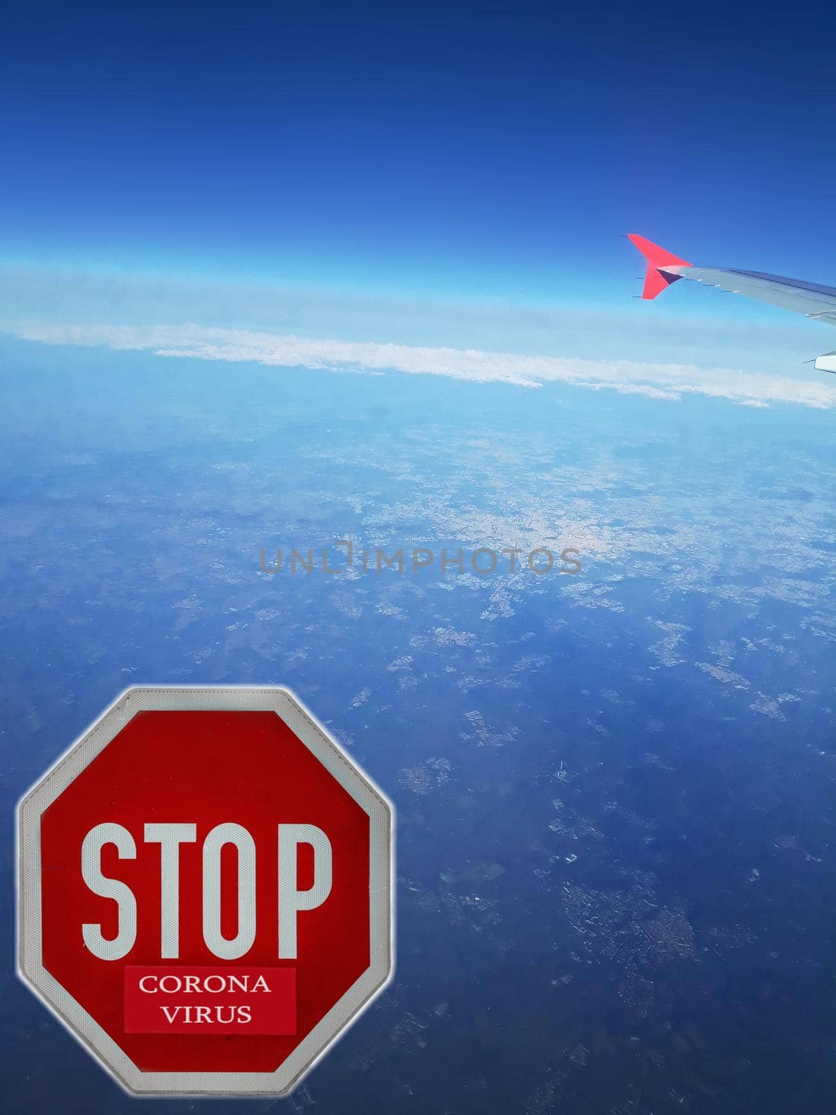 Covid-19 Virus. View from plane window to China country with coronavirus written on stop sign. Landing of passanger airplane.