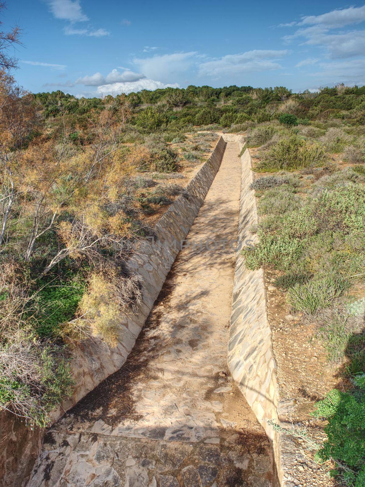 Close up of dry concrete drained channel,  by rdonar2