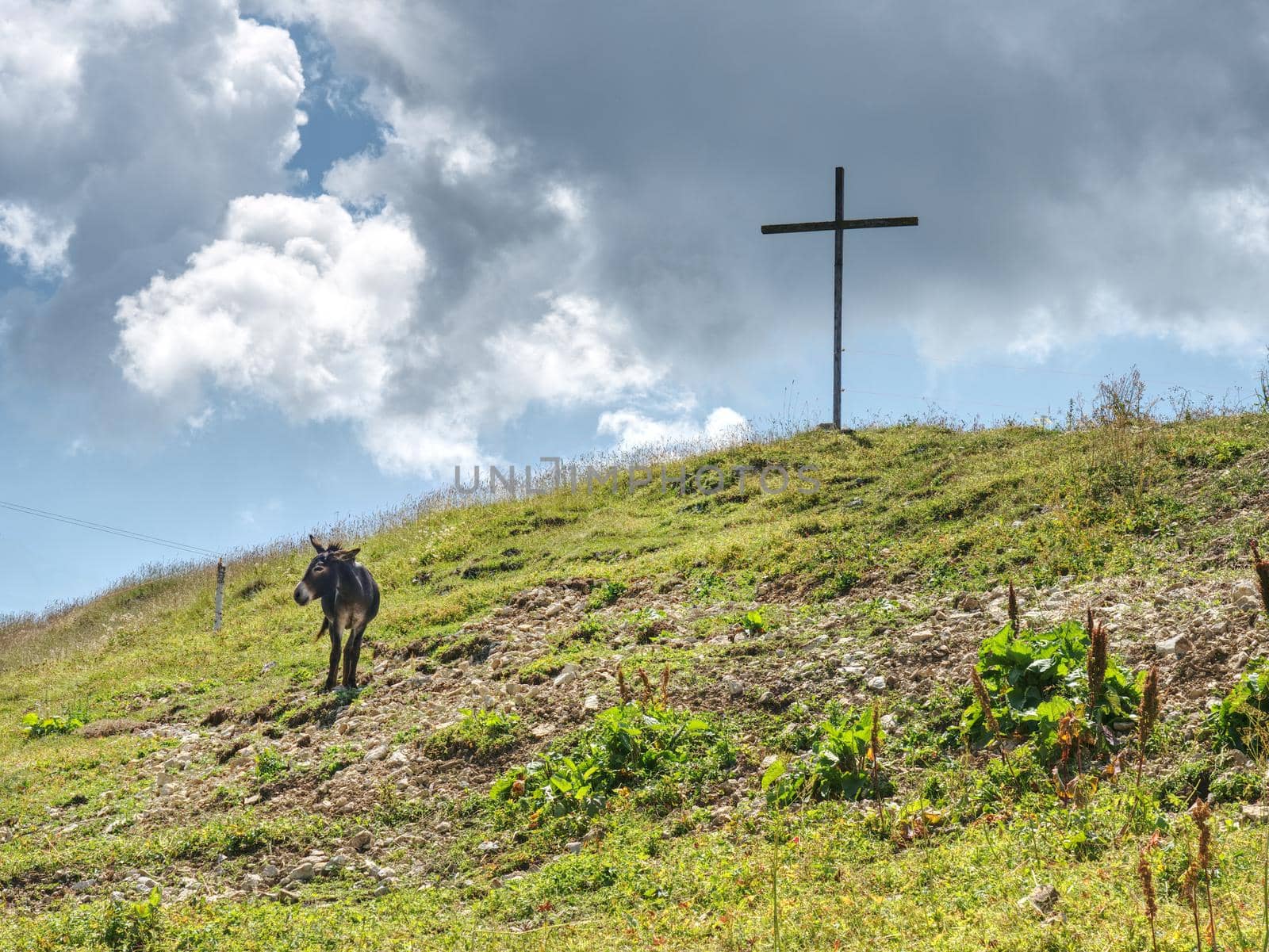Peak of mountain with cross for memory to victims. Manrvelous day in summer